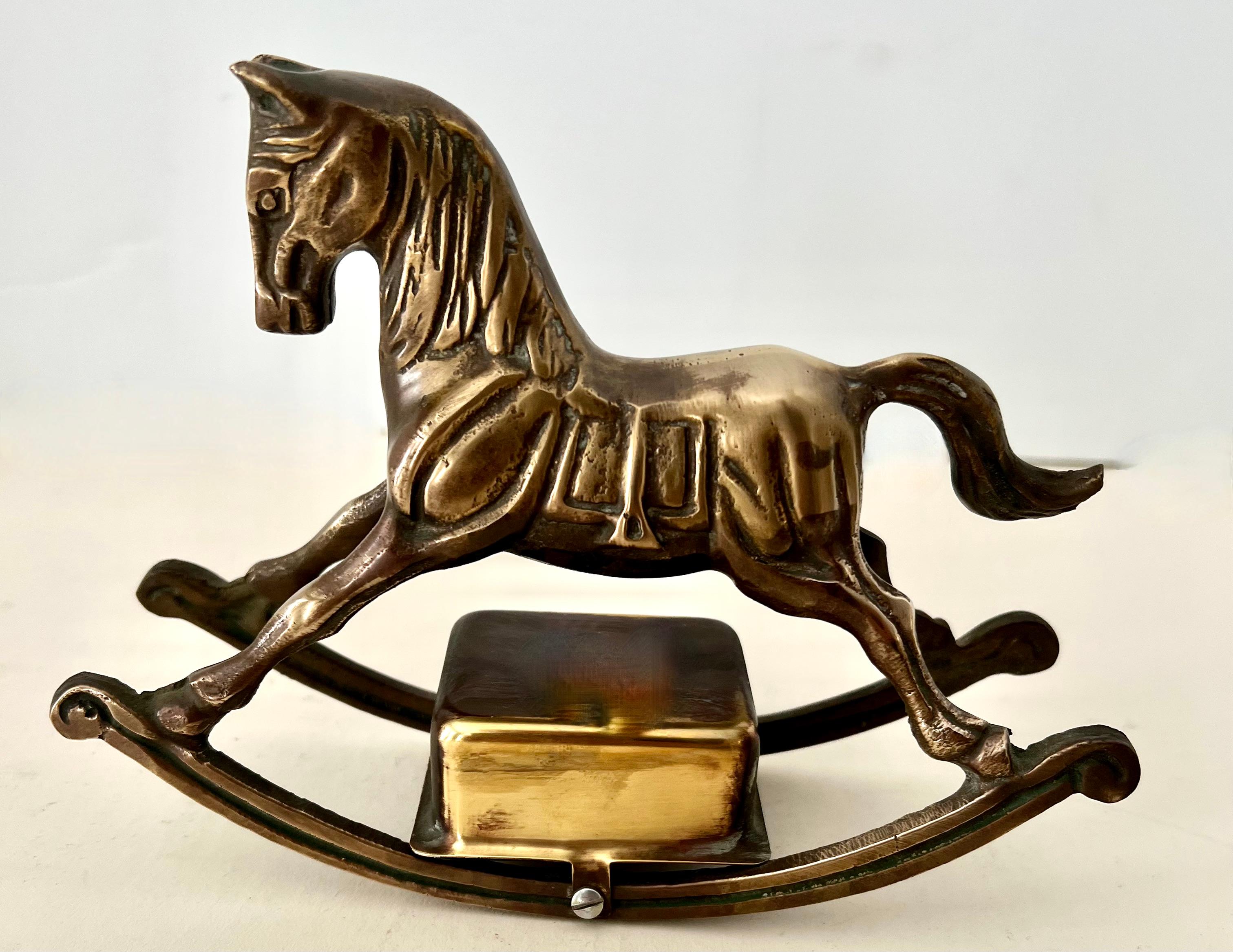 A brass rocking horse with a music box attached to the base. The piece is well designed and a very sweet piece. Perfect for the baby or Childs room. The music box works, and while it plays a slow melody, we are not sure of the actual song?

A