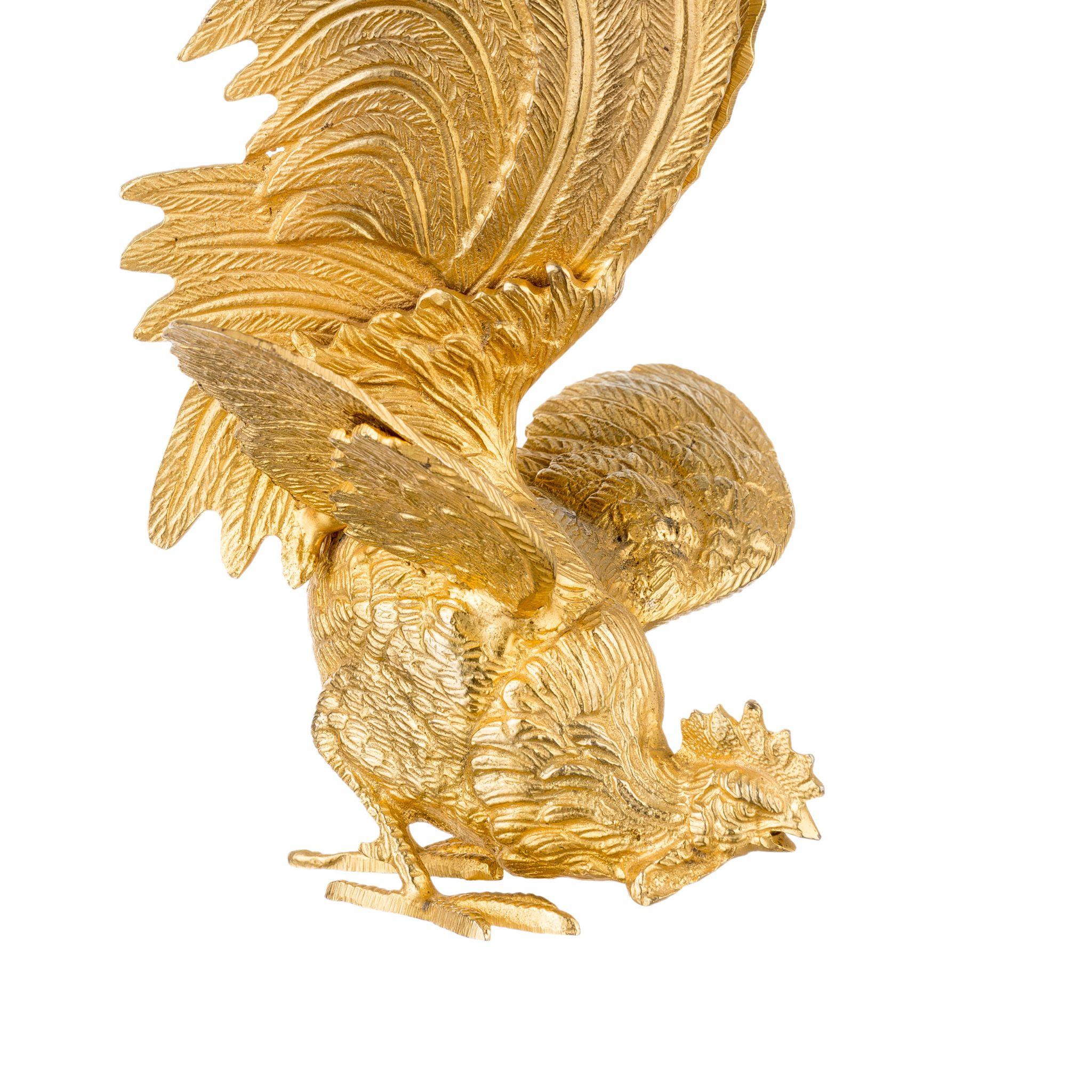 This brass rooster figurine adds a touch of country charm to any space. Handcrafted from durable brass and perched on a sleek stone base, this piece is as sturdy as it is stylish. The intricate details of the rooster's feathers and features are
