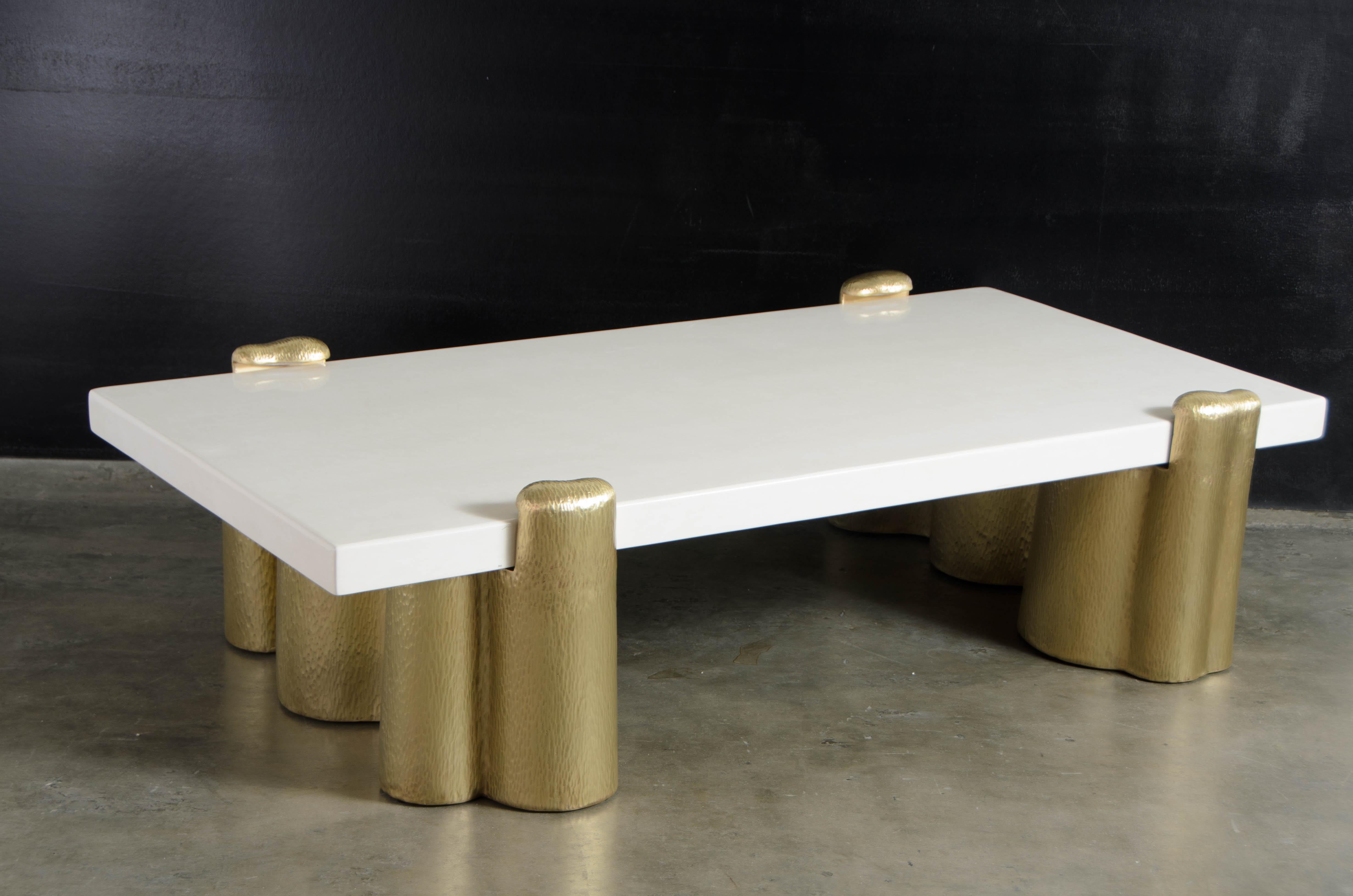 Brass root cocktail table base set w/ cream lacquer top.
Hand Repoussé
Brass
Cream lacquer
Hand made
Limited edition
Contemporary

Repoussé is the traditional art of hand-hammering decorative relief onto sheet metal. This technique involves