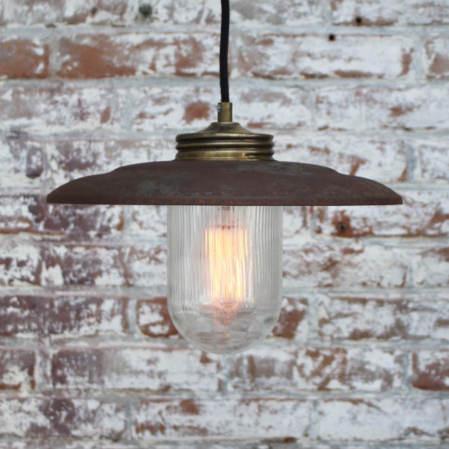 Rust iron Industrial hanging lamp.
Clear striped glass with brass top.

Weight: 1.20 kg / 2.6 lb

Priced per individual item. All lamps have been made suitable by international standards for incandescent light bulbs, energy-efficient and LED bulbs.