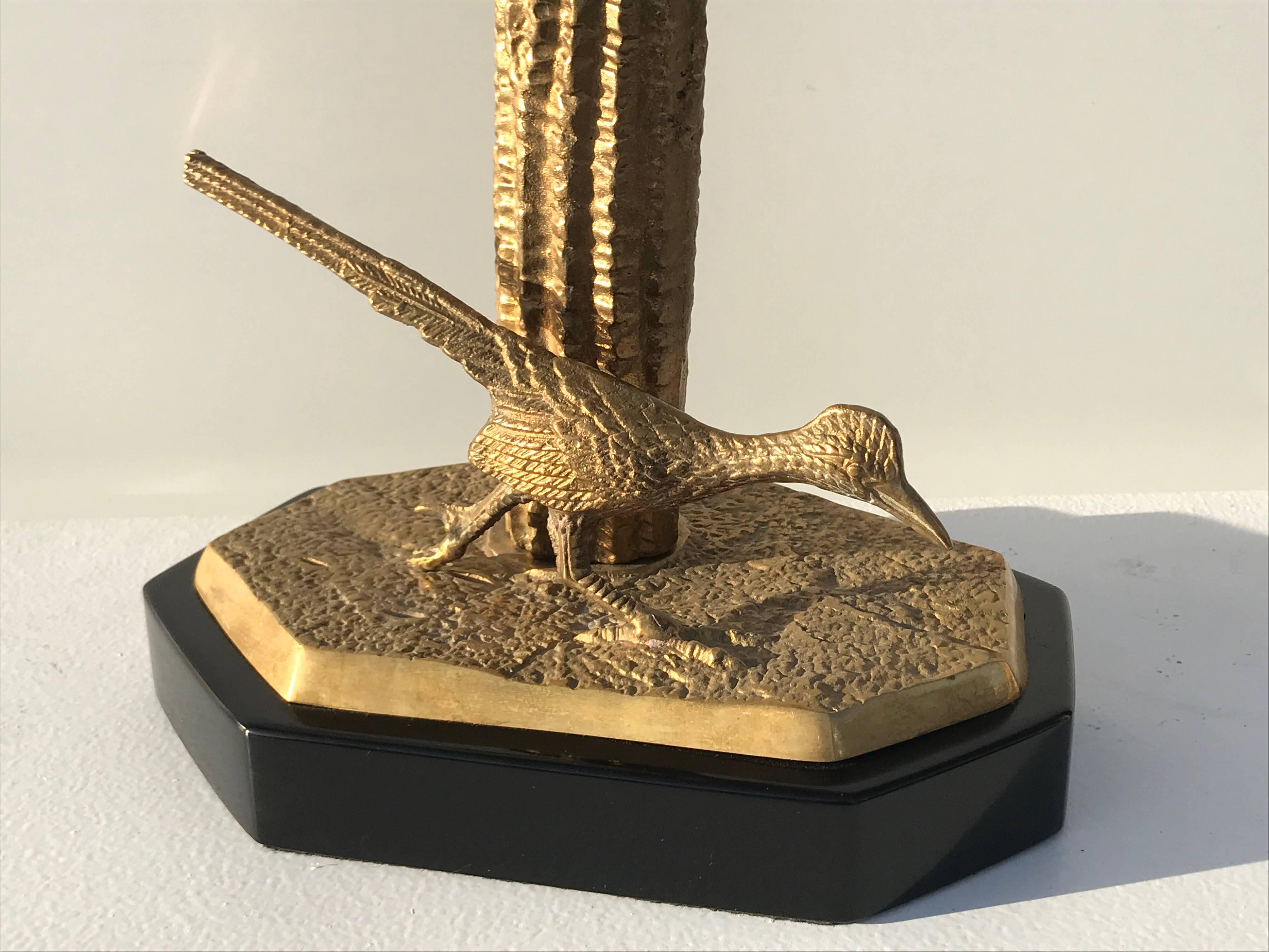 Brass Saguaro cactus sculpture with roadrunner. Top has a hole so it can be converted into a lamp if desired just like our pair of cactus lamps 1stdibs reference number LU98505994453.

Offered at Gallery Girasole