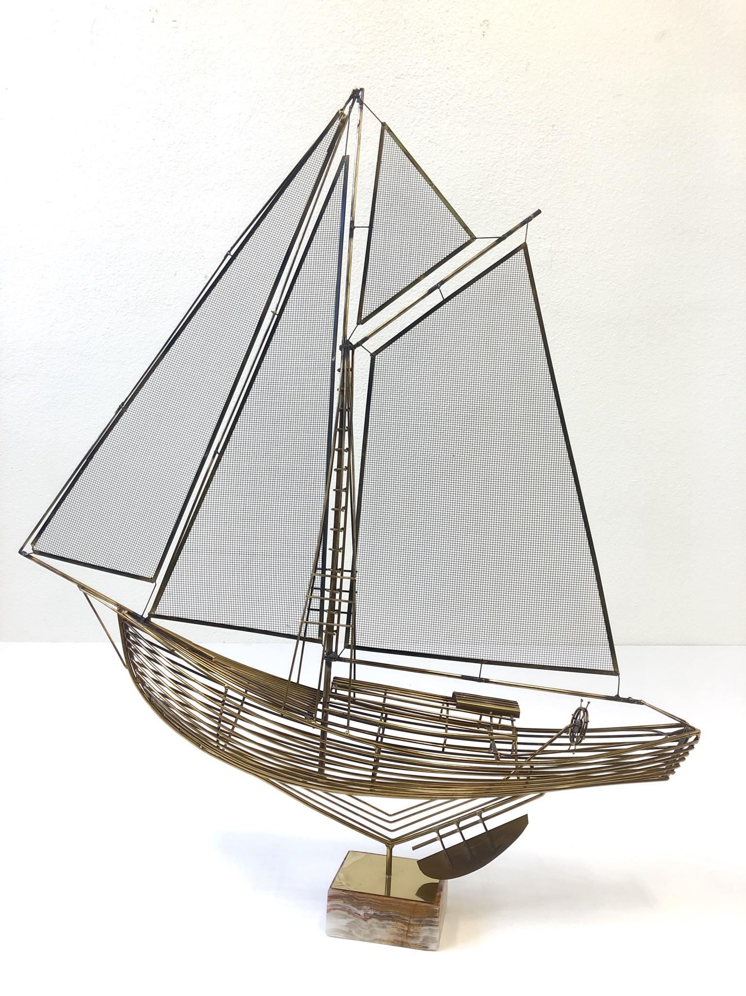 A beautiful brass sailboat sculpture designed by Curtis Jere in the 1970s. The sculpture sits in a salad onyx base.
Dimension: 40” wide, 47” high, 9” deep.