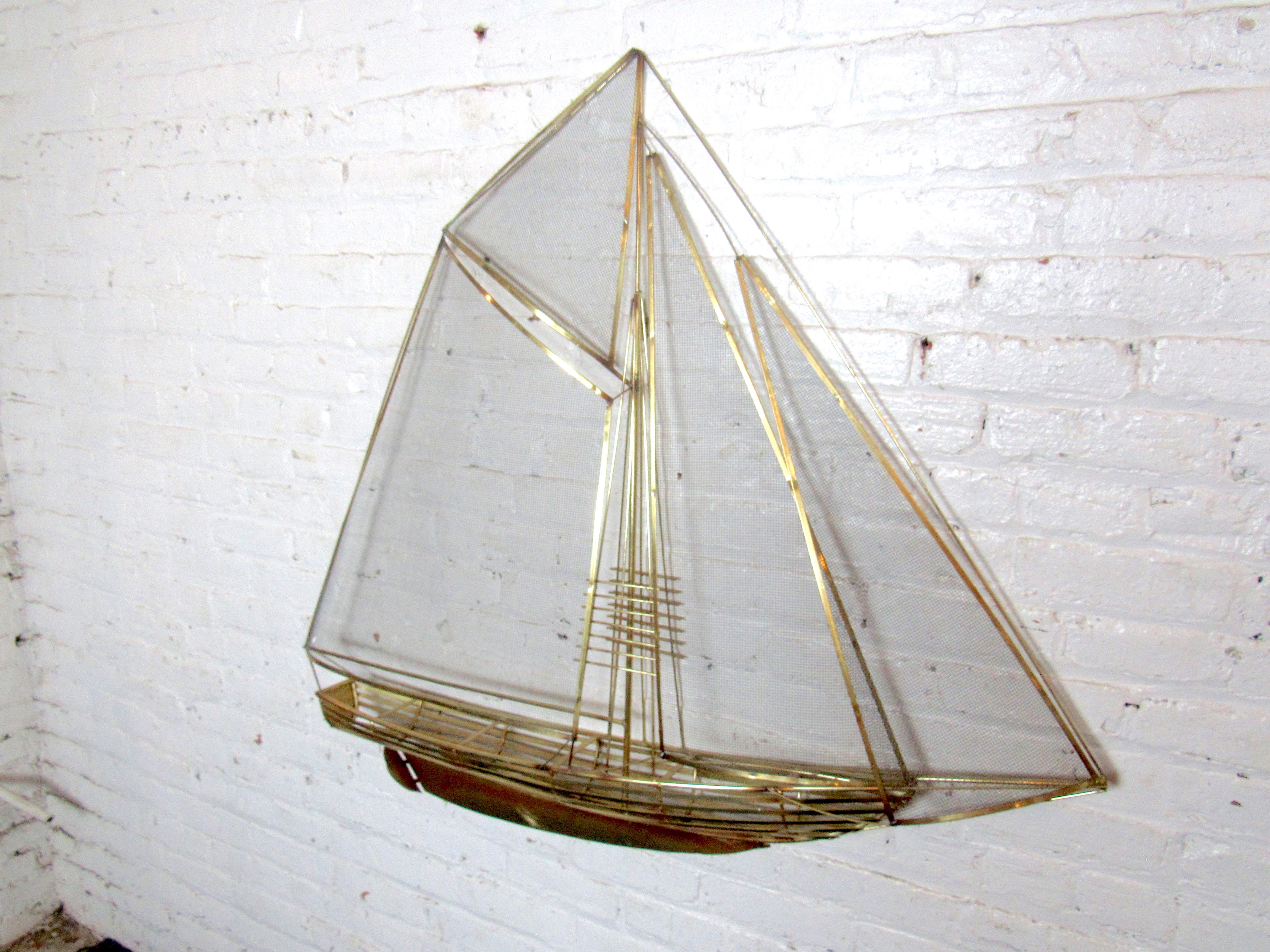 Intricately crafted in brass, this large wall-mounted sailboat sculpture is styled after the art of C. Jere. Please confirm item location with seller (NY/NJ).