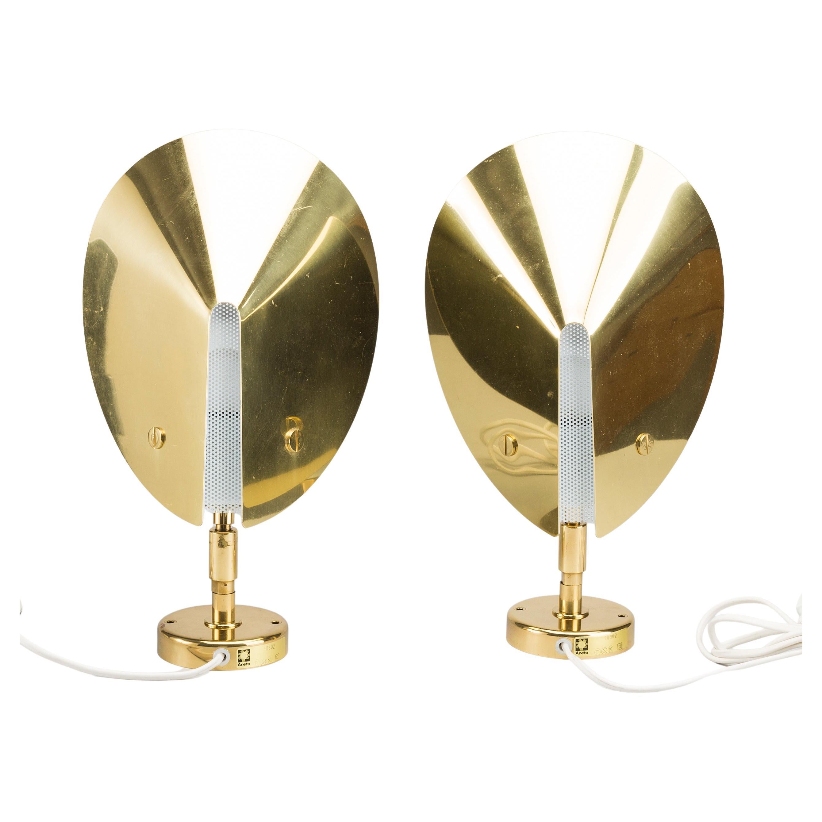 Pair of conical brass wall lights by Aneta, Sweden 1980. The sconces can be up lights or down lights and can adjust according to where you would like the light to project.
Accented by white perforated centre panels. Would look heavenly as bedroom