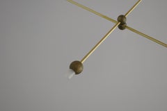 Sospensione luminosa scolpita in ottone, "Let's Talk" di Periclis Frementitis