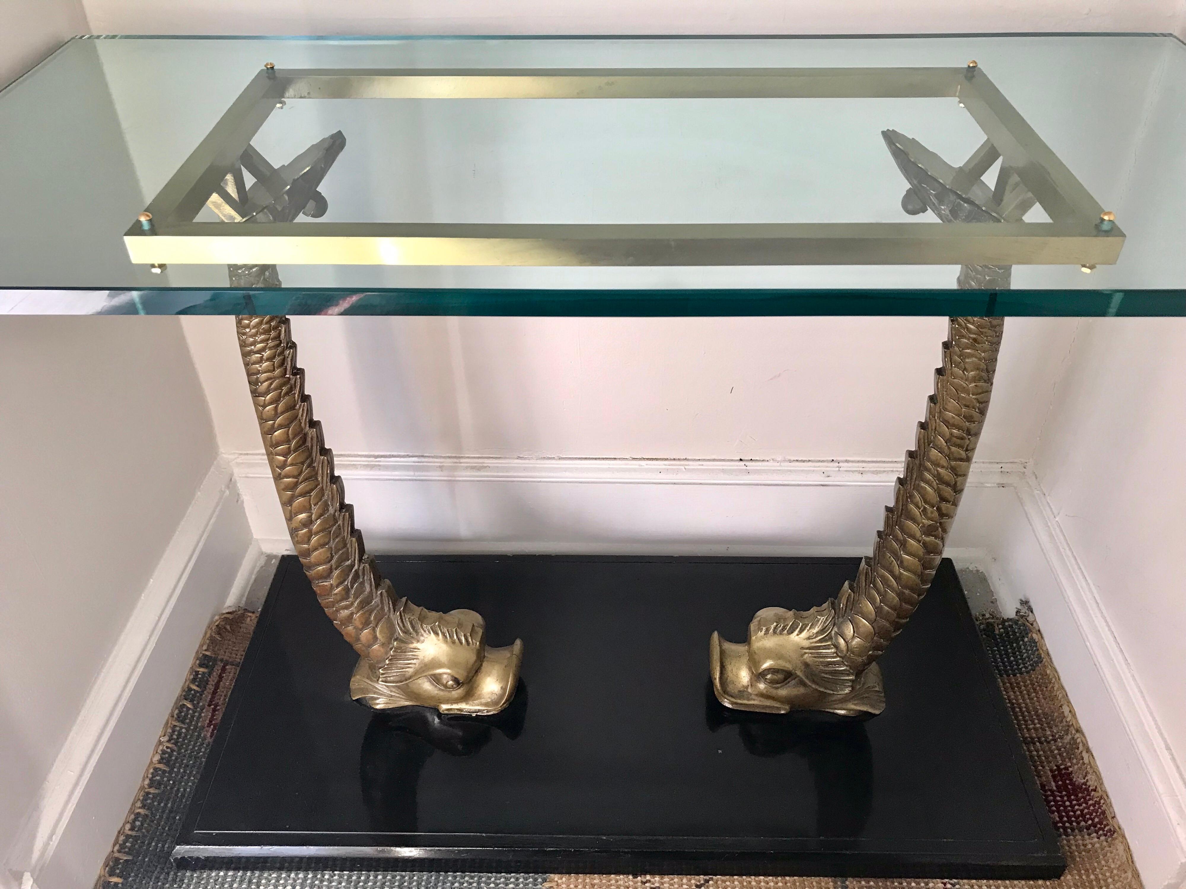 Vintage brass koi fish base with three quarter inch thick glass top. Mounted on a black painted wood base. Made in Italy.