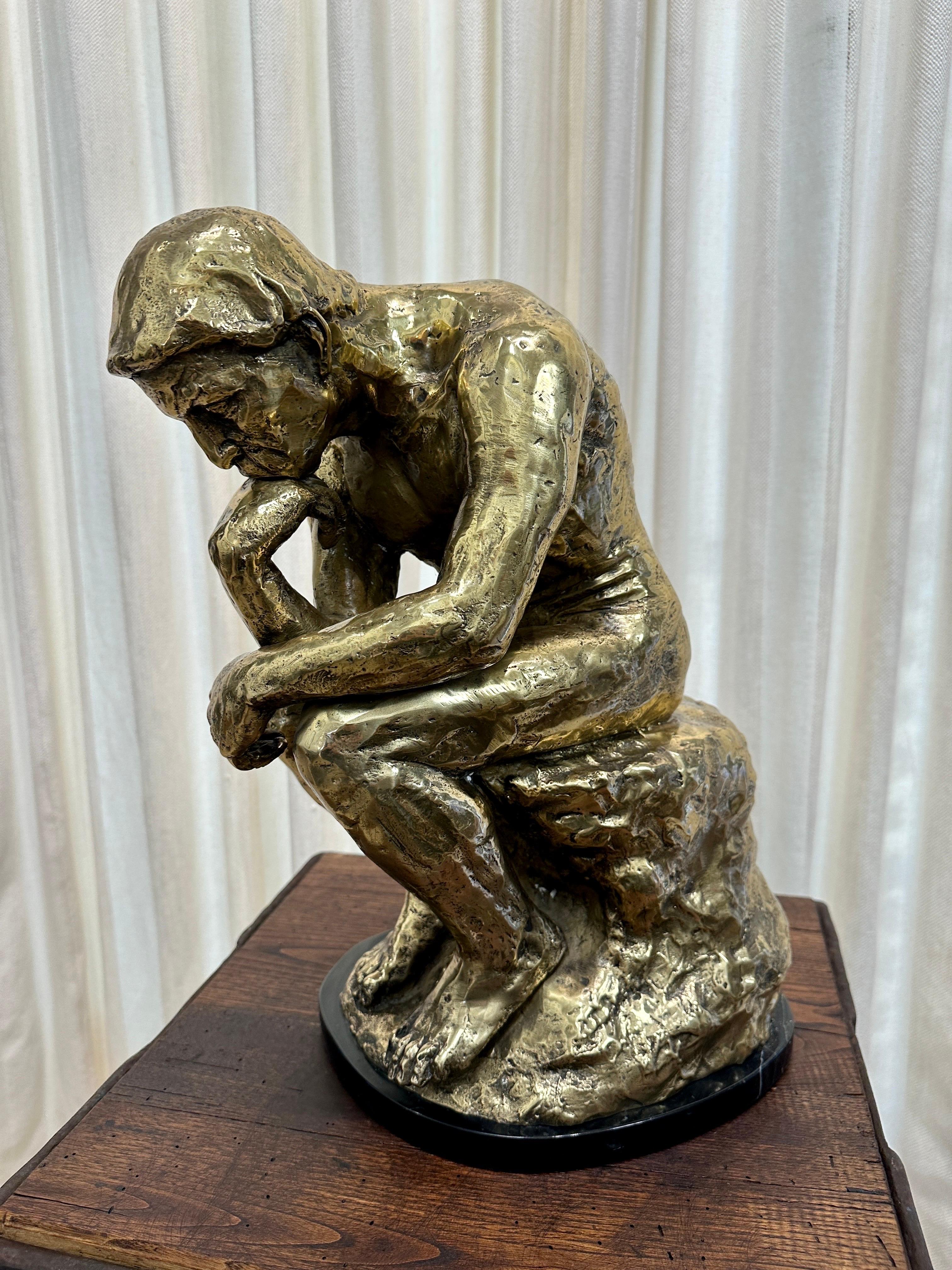 Signed V. Martin, this wonderful version of Rodin's renowned sculpture, The Thinker, is made of patinated brass and sits atop a black marble base.  Pedestal shown is sold separately BUT is perfect for this piece.  THIS ITEM IS LOCATED AND WILL SHIP