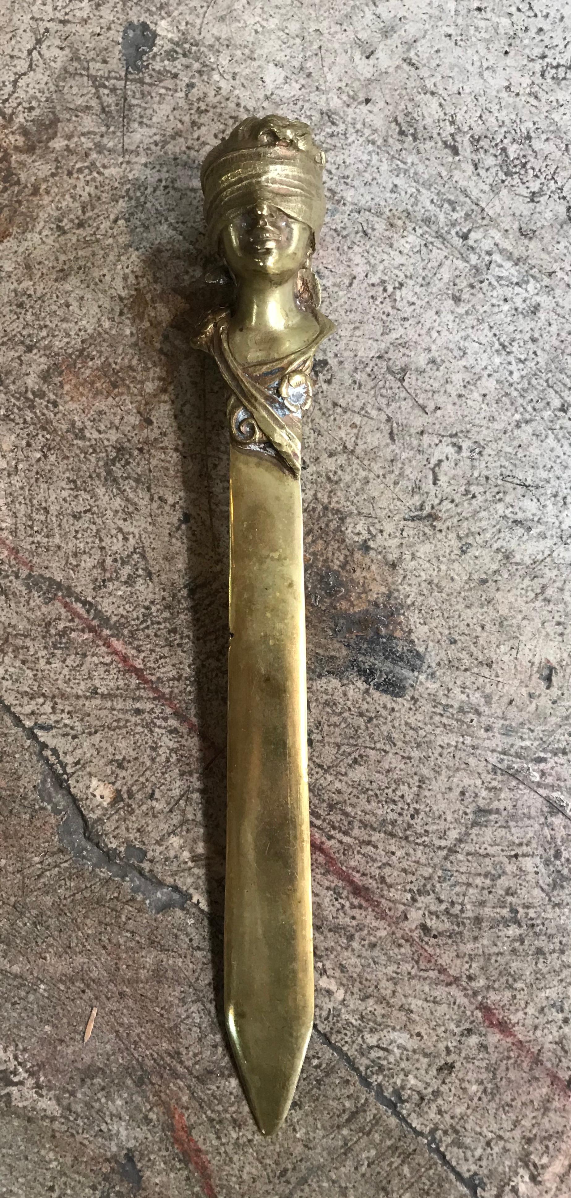 This unique desk accessory in the way of a solid brass braided and sculptured letter opener is a divine way to open up mail and accept checks. It is from the period of Art Nouveau and has good weight to it. This makes a great gift! It is vintage