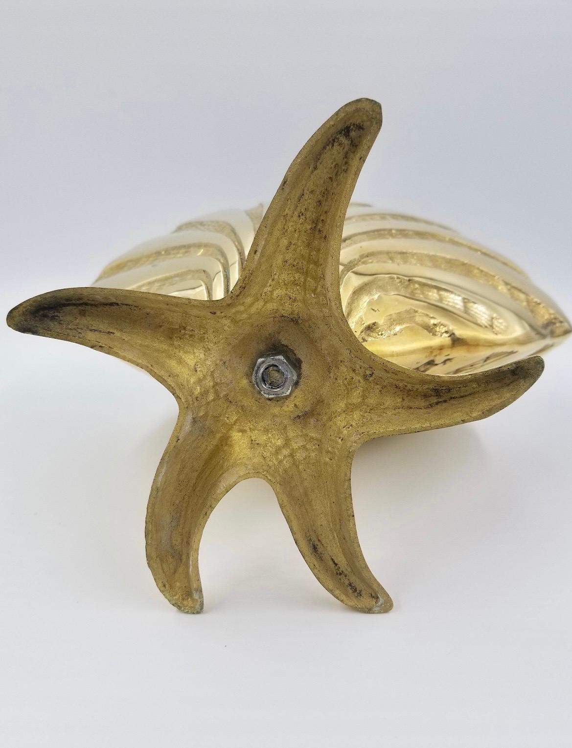 Brass sea shell nautilus planter on starfish base. This is one planter of two matching planters. Good condition. Great for your beach house!