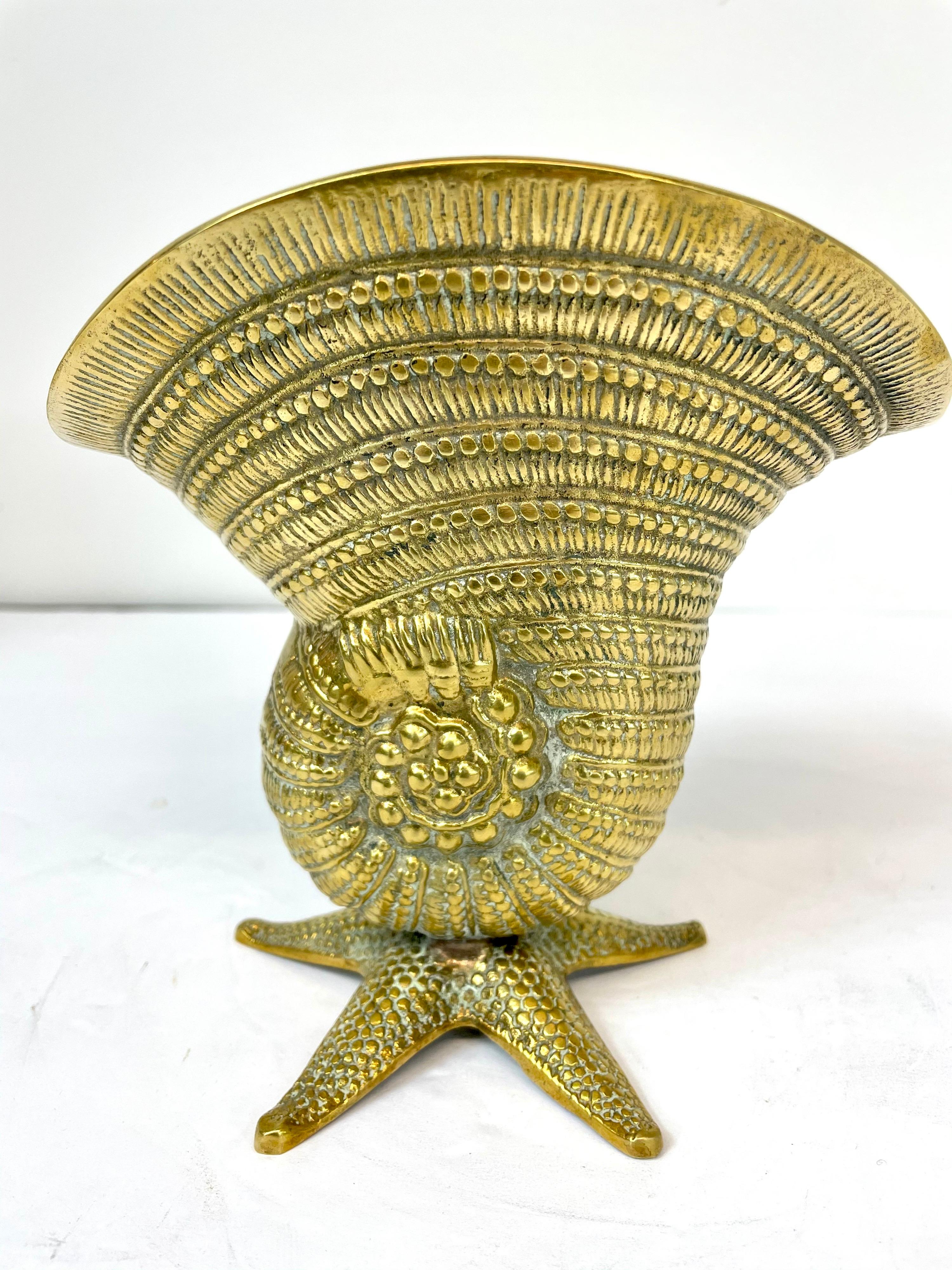 Brass sea shell on starfish base. Hand polished. Nice statement piece. Very unusual design with nice detail. Overall nice condition. Ready for your beach house! 