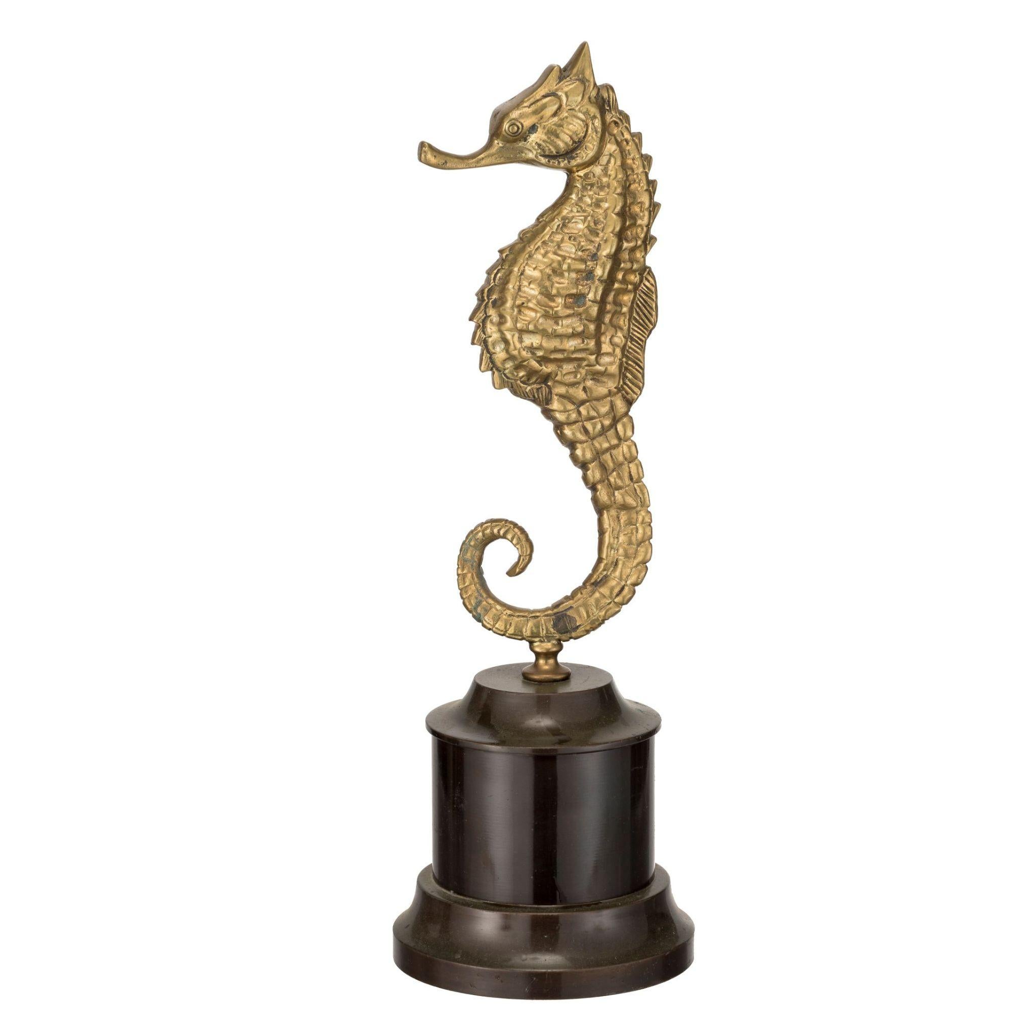 This beautiful brass seahorse is a stunning addition to any coastal or nautical-themed decor. With intricate detailing and a unique, eye-catching design, this piece is sure to impress. The seahorse is set on a solid black marble base, providing