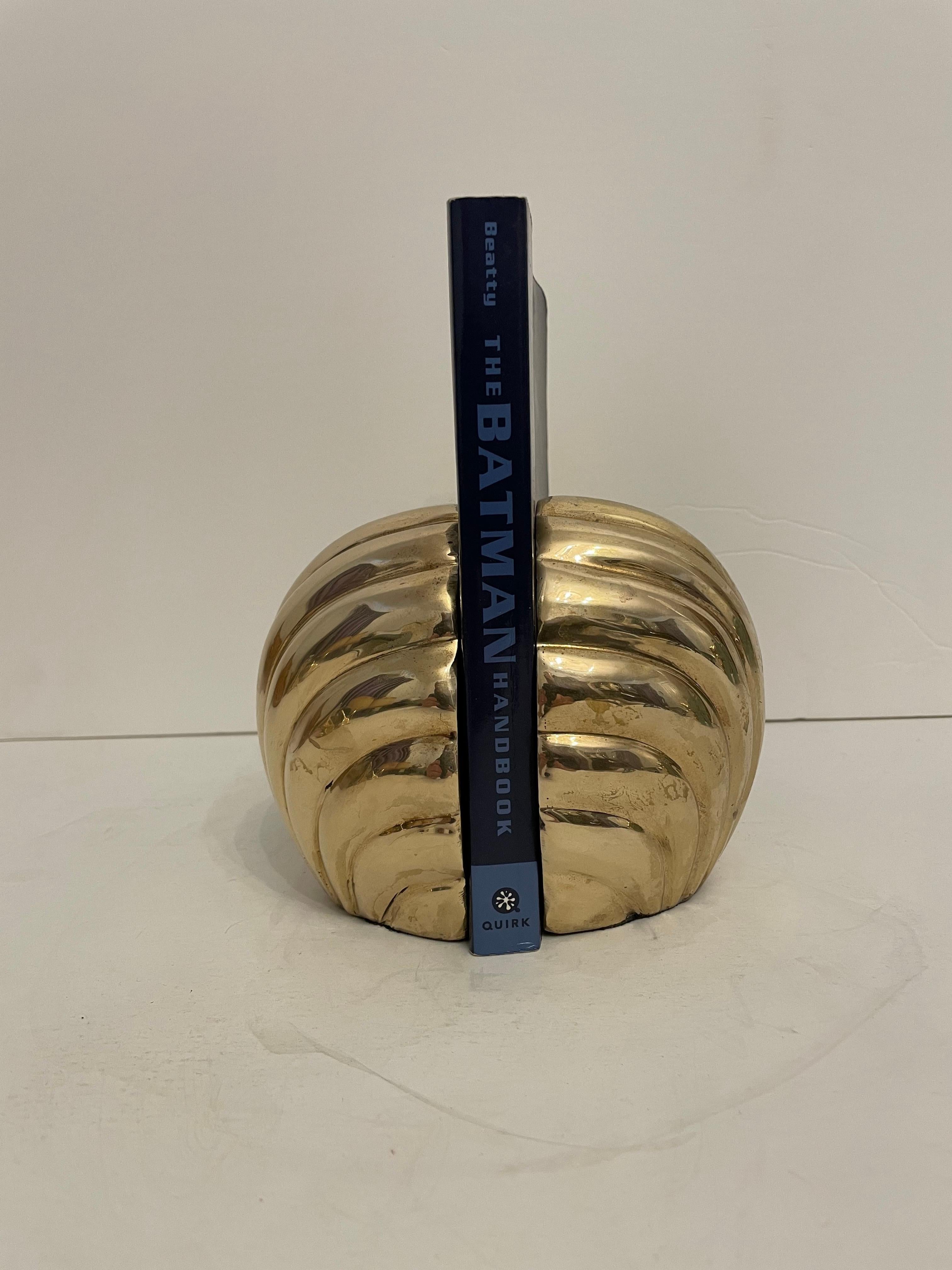 Brass Seashell Bookends. Nice weight to hold a stack of books. Good overall condition. Dark and light spots are reflection. Hand polished.