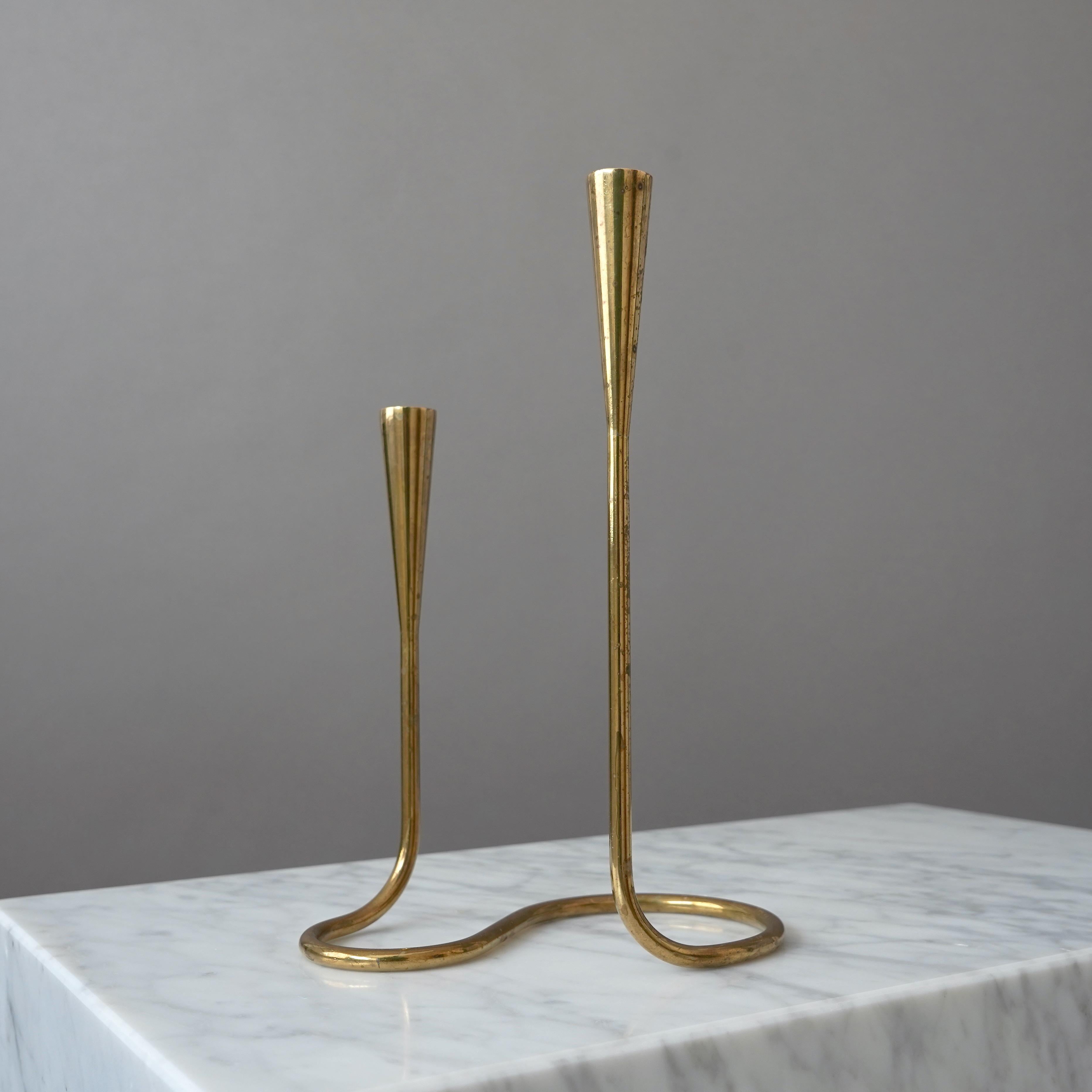 Vintage solid brass serpentine candlestick for two candles.
Made by Illums Bolighus. Copenhagen, Denmark, 1950s

Great condition with amazing patina. If you prefer them shiny you can easily polish them.

Marked with the impressed 'Illums Bolighus'