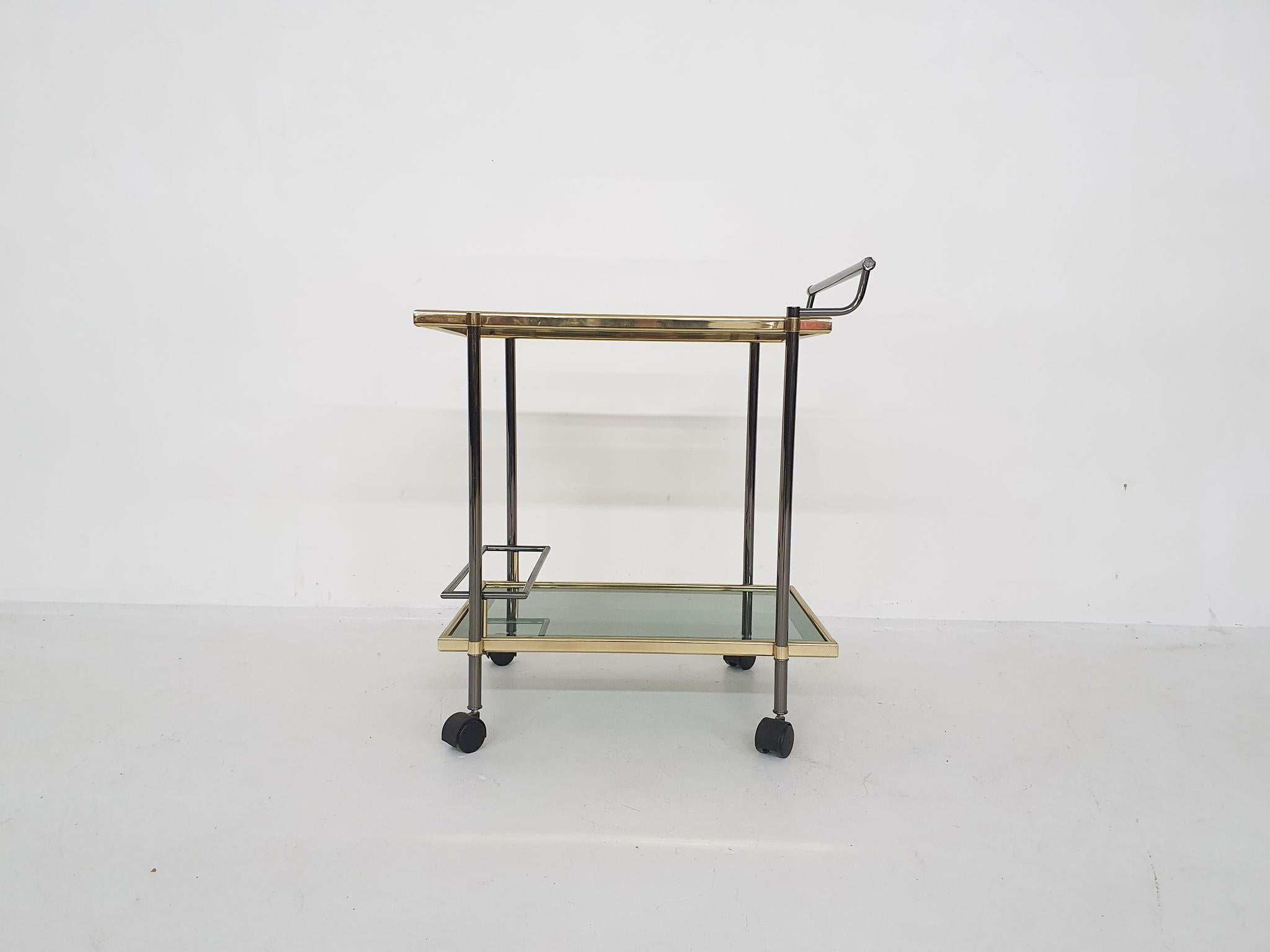 Bar cart with smoked glass top and shelf
In good condition.