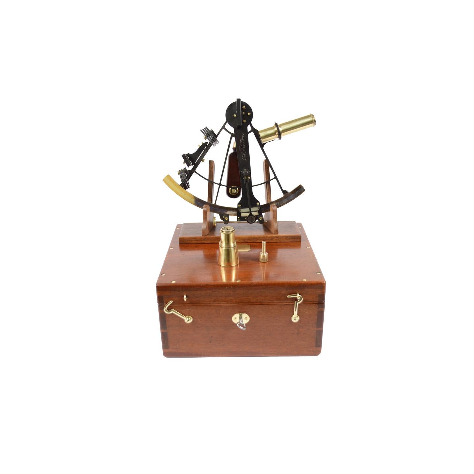 Brass sextant signed Buff & Buff Mfg Co Boston USA 5588 made in the beginning of the XX century, complete with lenses and compass placed in its original mahogany box complete with key lock and brass hinges. Silver flap and vernier, wooden handle, 3