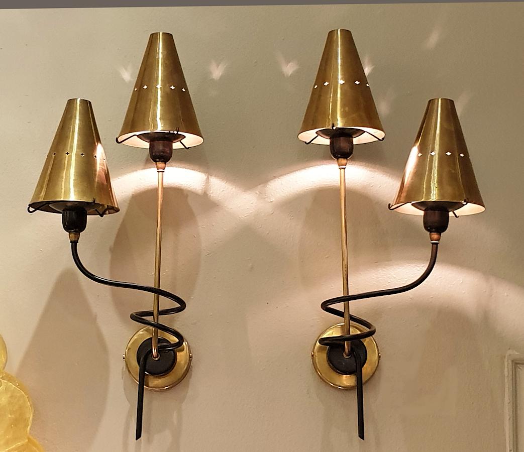 Pair of stylish brass and black painted metal Mid-Century Modern sconces, attributed to Stilnovo, Italy.
Probably designed by Sciolari, who worked with Stilnovo during the 1960s.
They have 2 lights each, rewired with a candelabra base socket, and