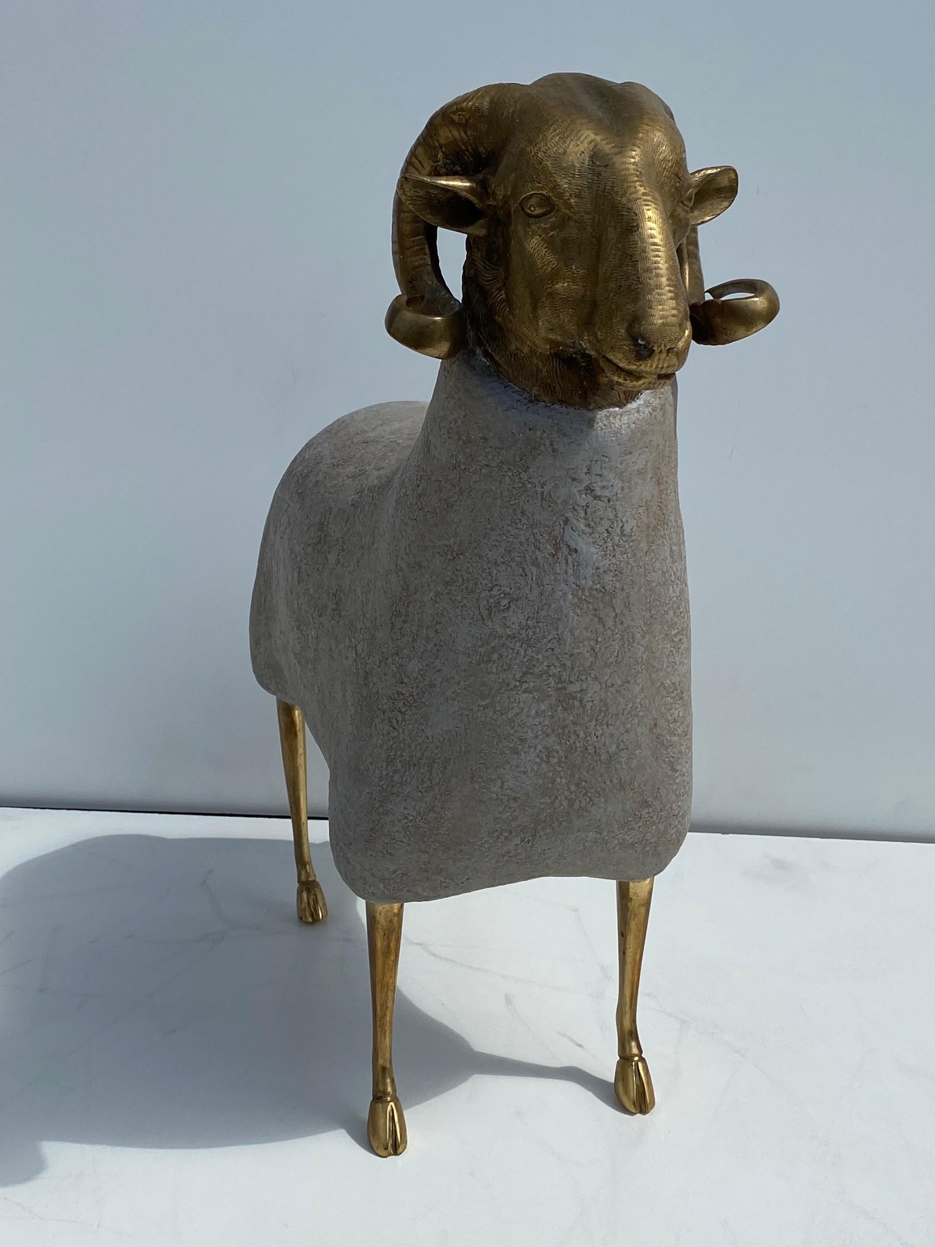Brass and faux concrete ram / sheep sculpture.  Suitable for indoor / outdoor but not advised to leave under the rain for a long period of time.