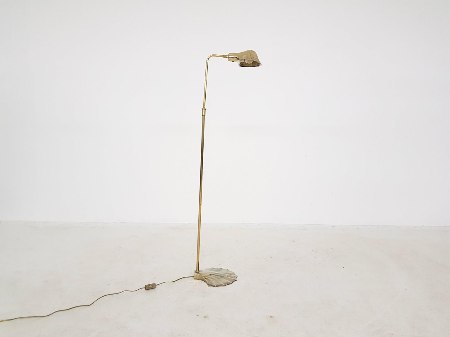 Solid brass floor lamp. Shell shaped foot and lamp shade. Lamp shade can be adjusted to left and right and the top of the light can rotate, when the foot stays still.