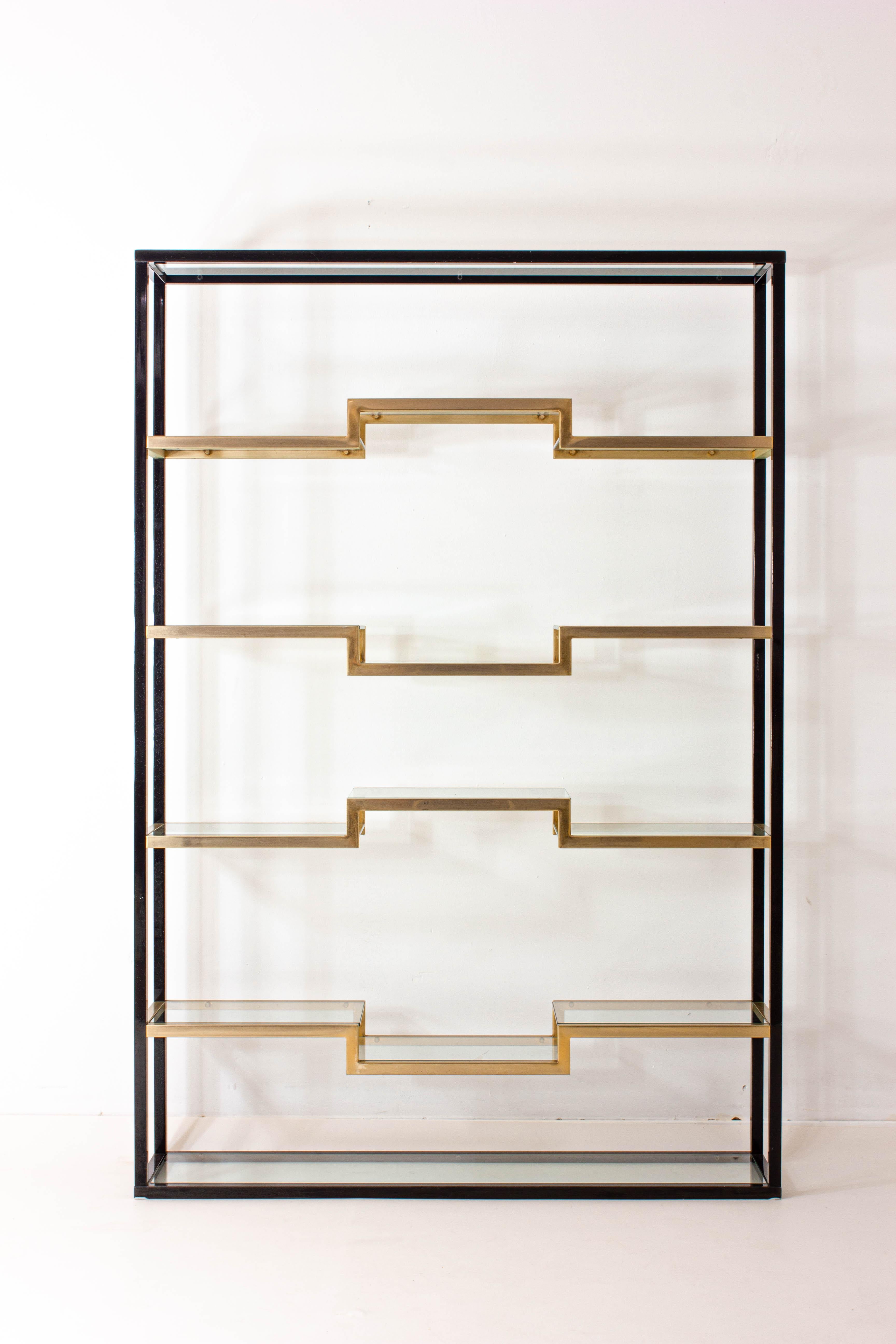 Introducing a masterpiece from the revered design era: The Belgo Chrom Brass and Black Lacquered Shelving Unit, meticulously crafted in the glamourous 1980s. This exquisite piece embodies the perfect harmony of timeless elegance and avant-garde