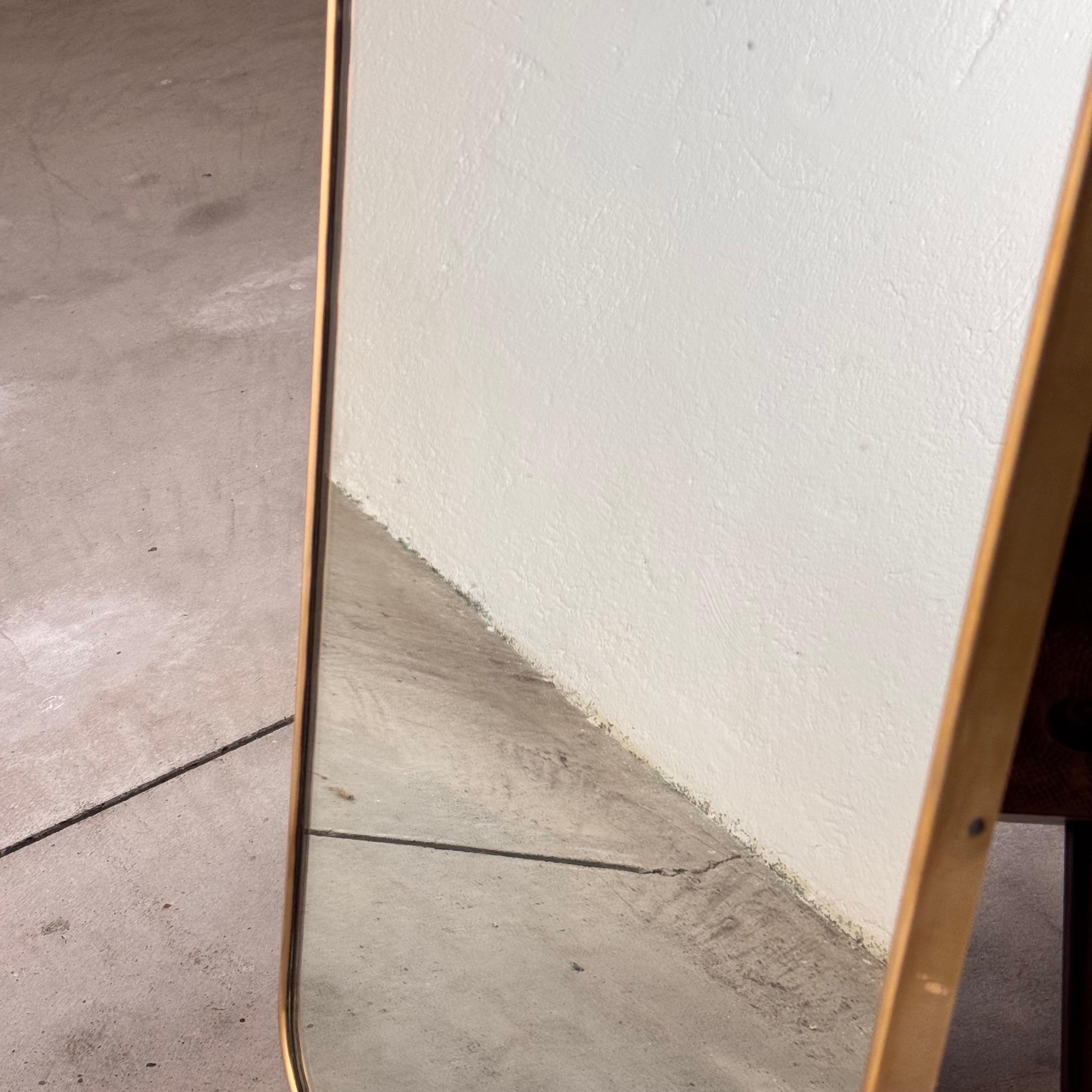 
This exclusive shield-shaped mirror, attributed to the iconic Gio Ponti, epitomizes mid-century Italian design. Crafted in the 1950s, it features a refined randaccio decoration on its brass frame. The brass has been meticulously polished, revealing