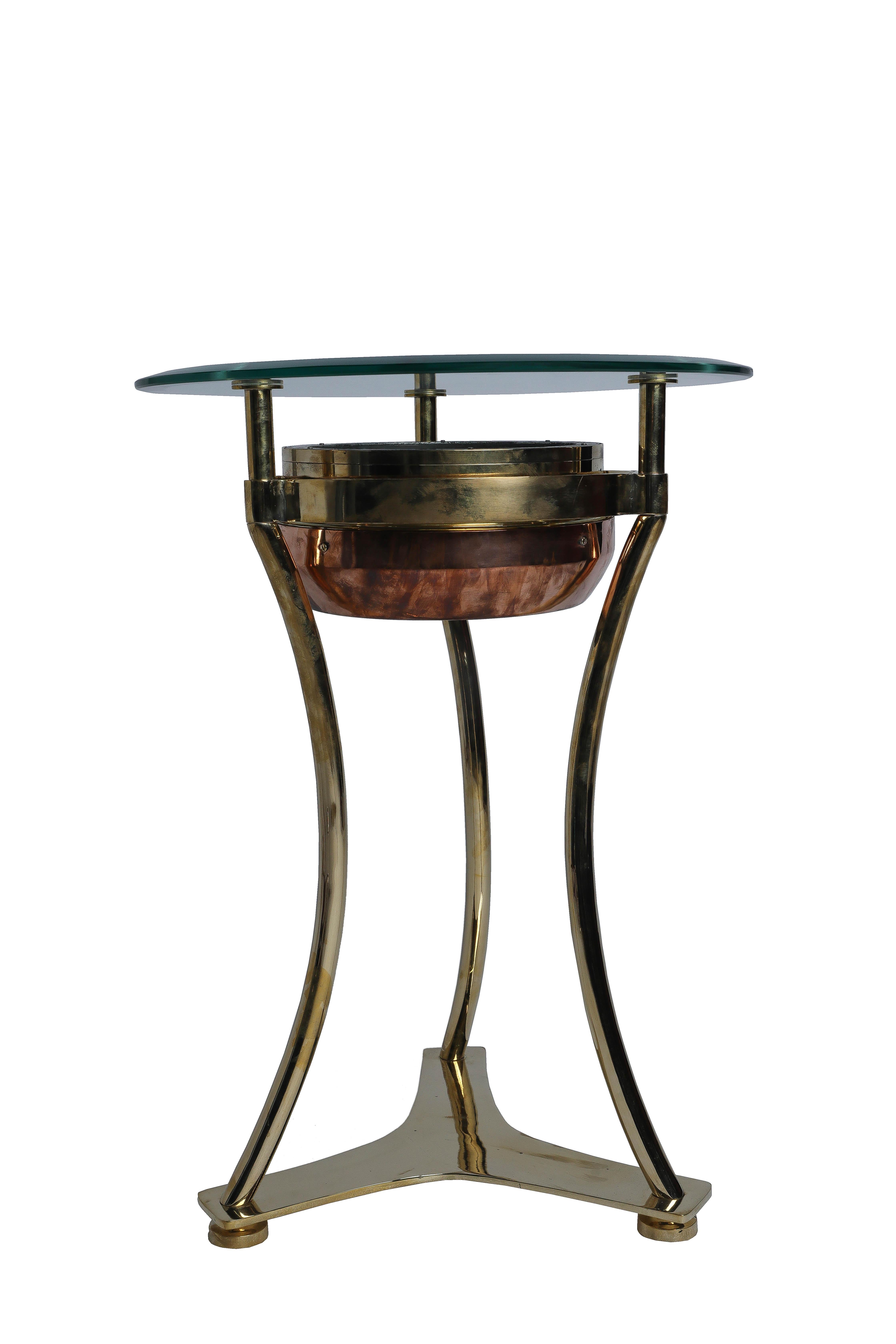 Original and rare ship's brass compass converted to a side table which was designed by Deborah Lockhart Phillips. These compasses usually exist in a box on a lifeboat. We had them polished and then created a design so that the compass still gimbals.