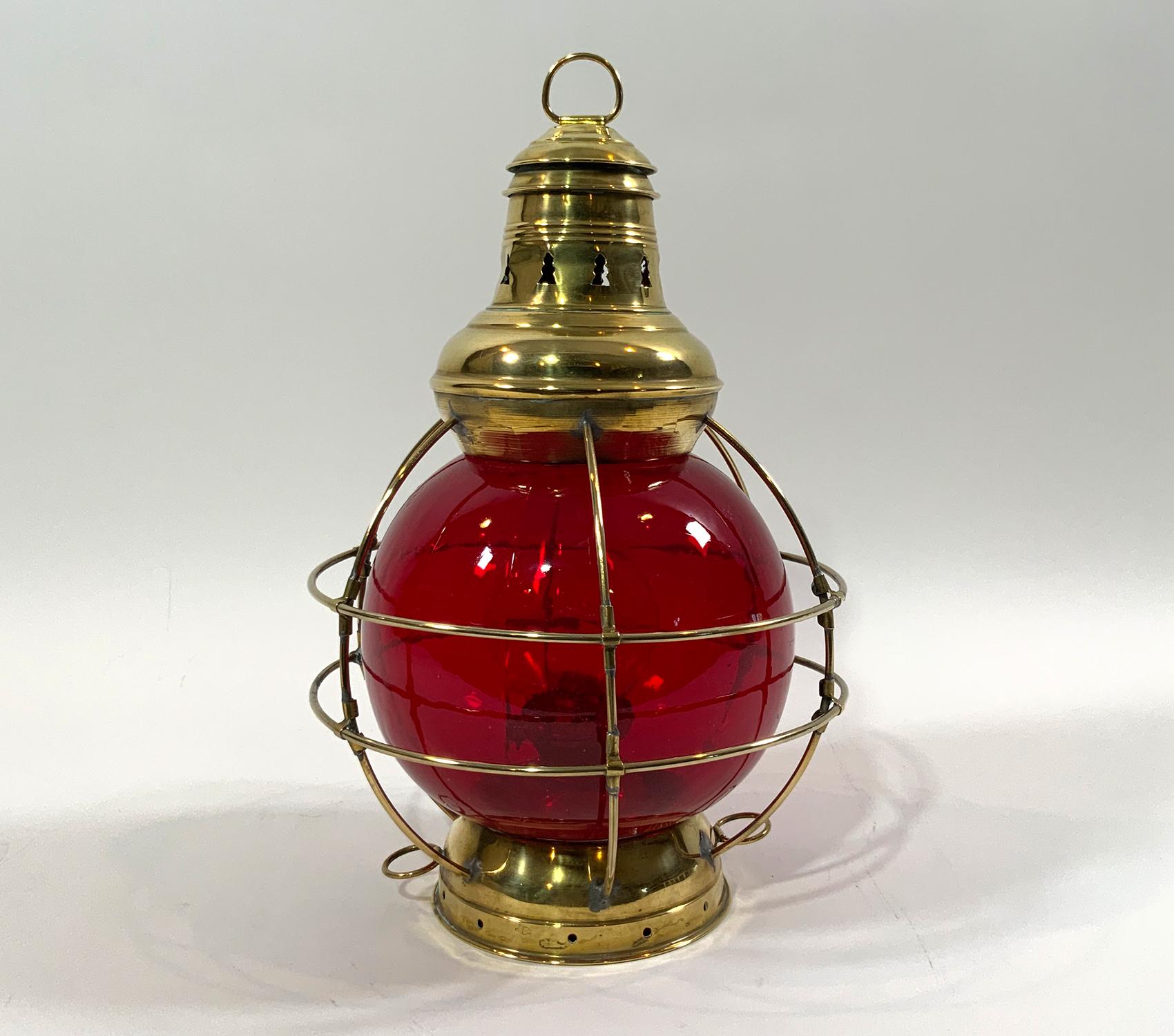 Solid brass Perkins eight-inch onion lamp with red lens. Highly polished. Oil burner with wick, tank, and glass chimney. Nice unit. Highly polished finish. With oil burner and glass chimney. 

Weight: 4 LBS
Overall Dimensions: 15” H x 10