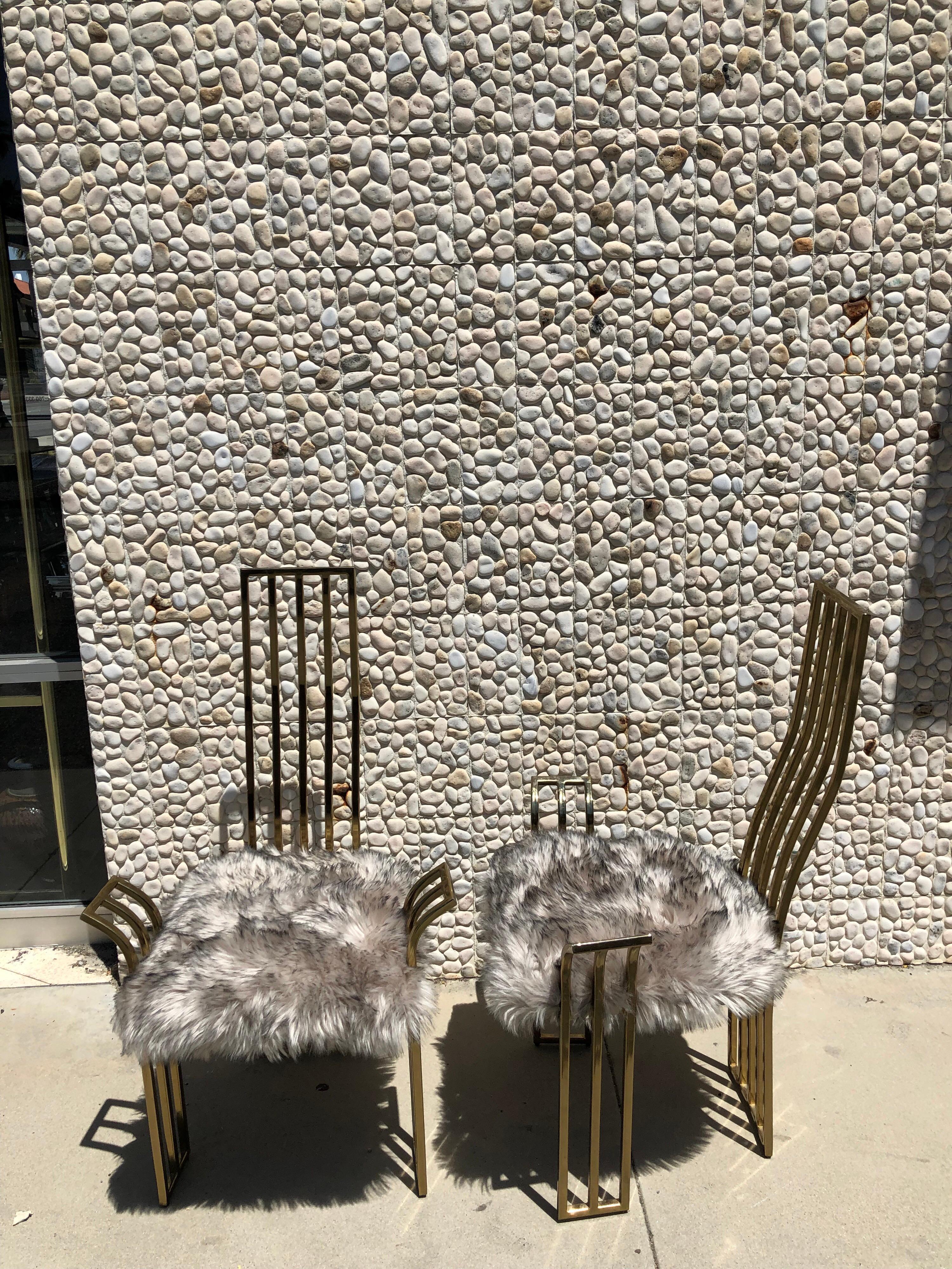 This pair of beautiful brass high back chairs are made of brass in the 1970s. Attributed to Pierre Cardin, they are made in Europe. Newly upholstered in a high end faux fur. The chairs were used in a very Glam house in Beverly Hills as the chairs of