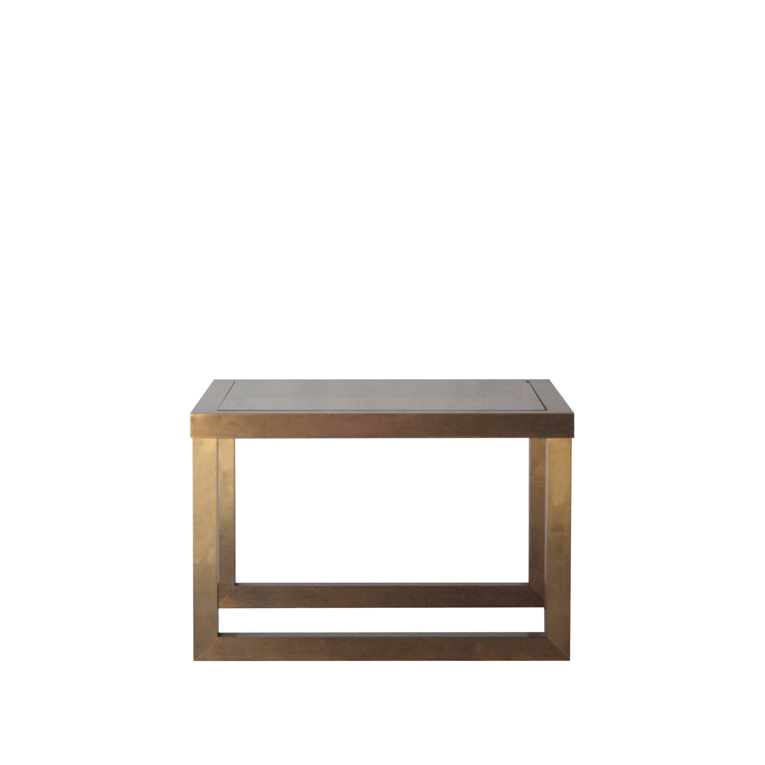 Side table with solid steel structure covered in brass, and smoked glass top.