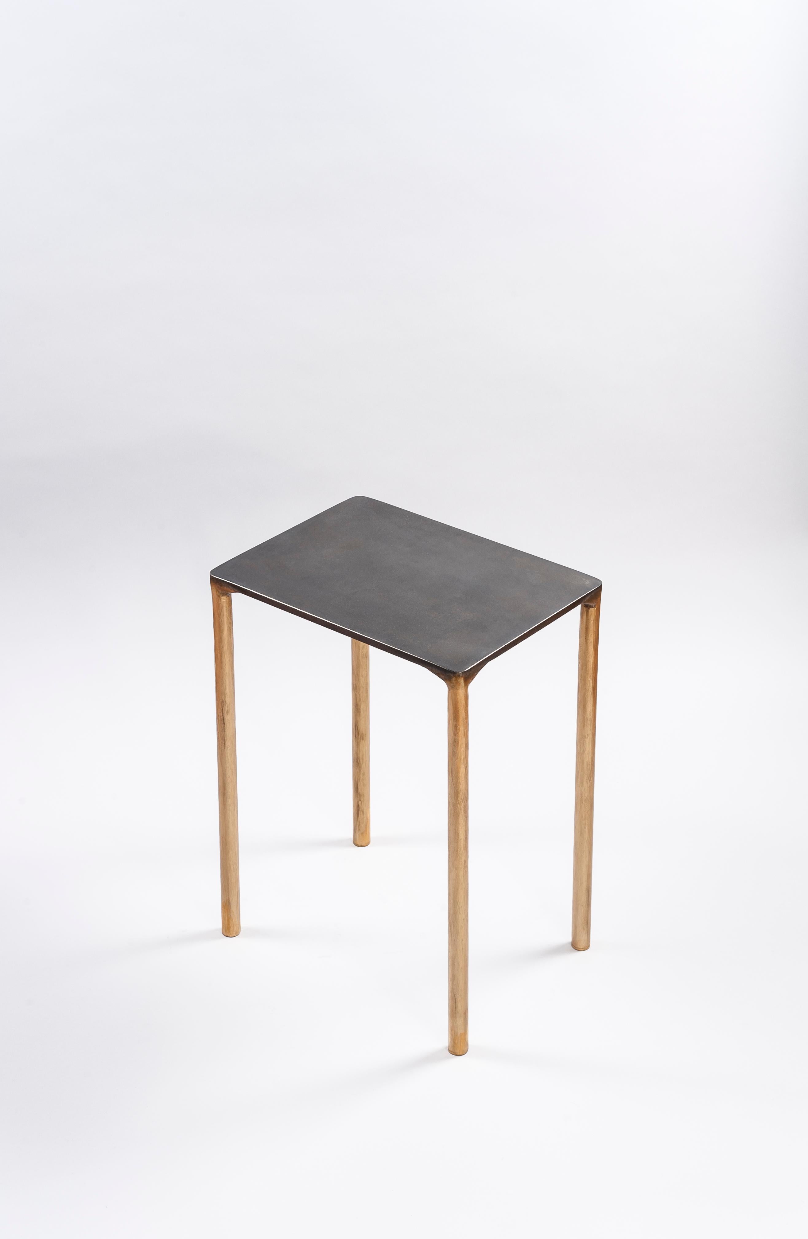 Brass side table signed by Lukasz Friedrich.
Materials: Solid Brass and Stainless steel.
Brass legs gently textured and patinated
Stainless top with special treatment and grey patina.
Dimensions: D 28 cm, L 38 cm, H 50 cm.
Signed and