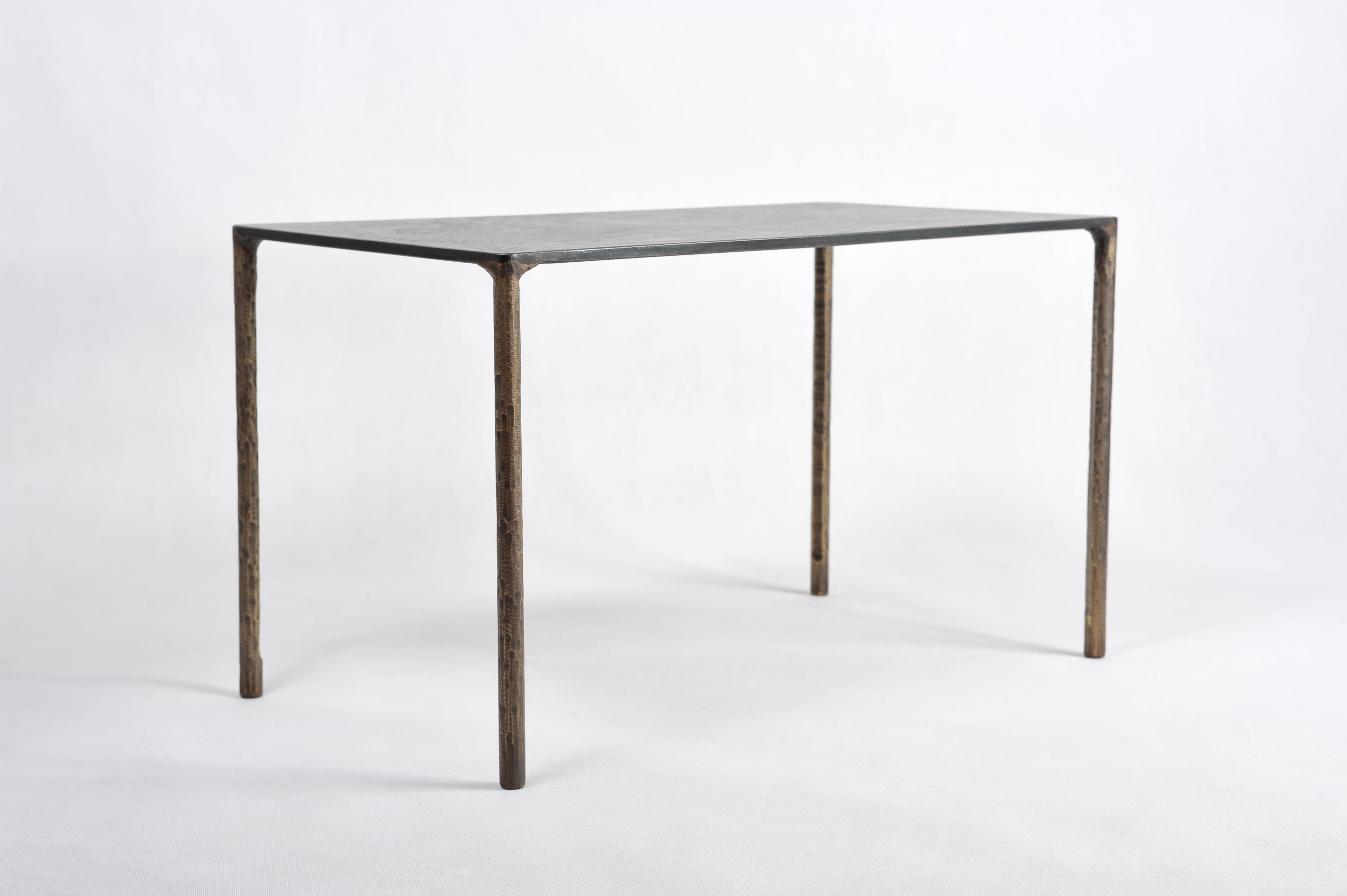 Brass side table signed by Lukasz Friedrich.
Textured side or coffee table.
Materials: Legs, patinated brass; top, patinated and waxed steel.
Dimensions: D 38 cm, L 68 cm, H 40 cm.
Signed and dated.

Lukasz Friedrich (born 1980), lives and