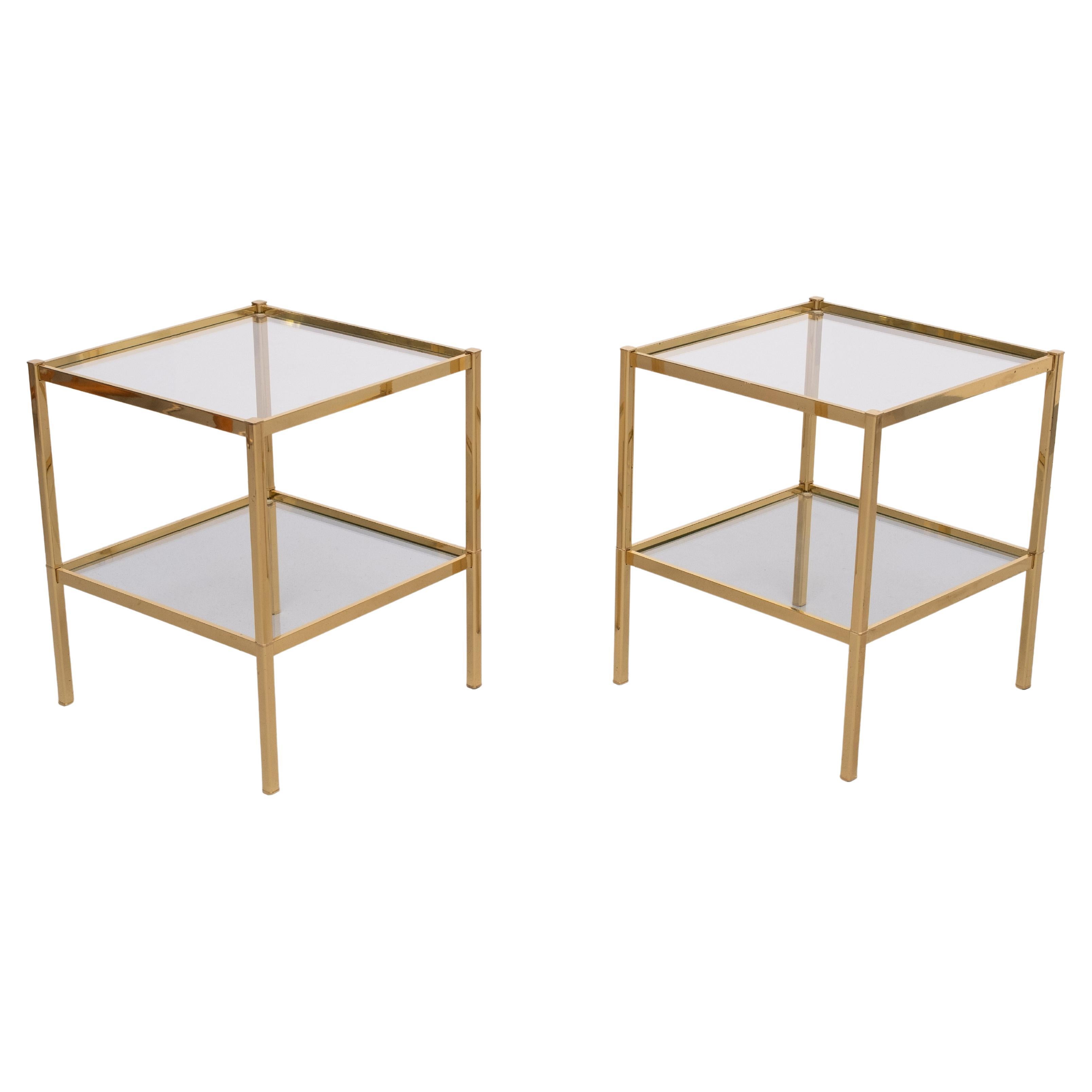 Beautiful Two tier side tables . Brass, comes with Smoked Glass tops 
1970s France . Very nice quality tables .