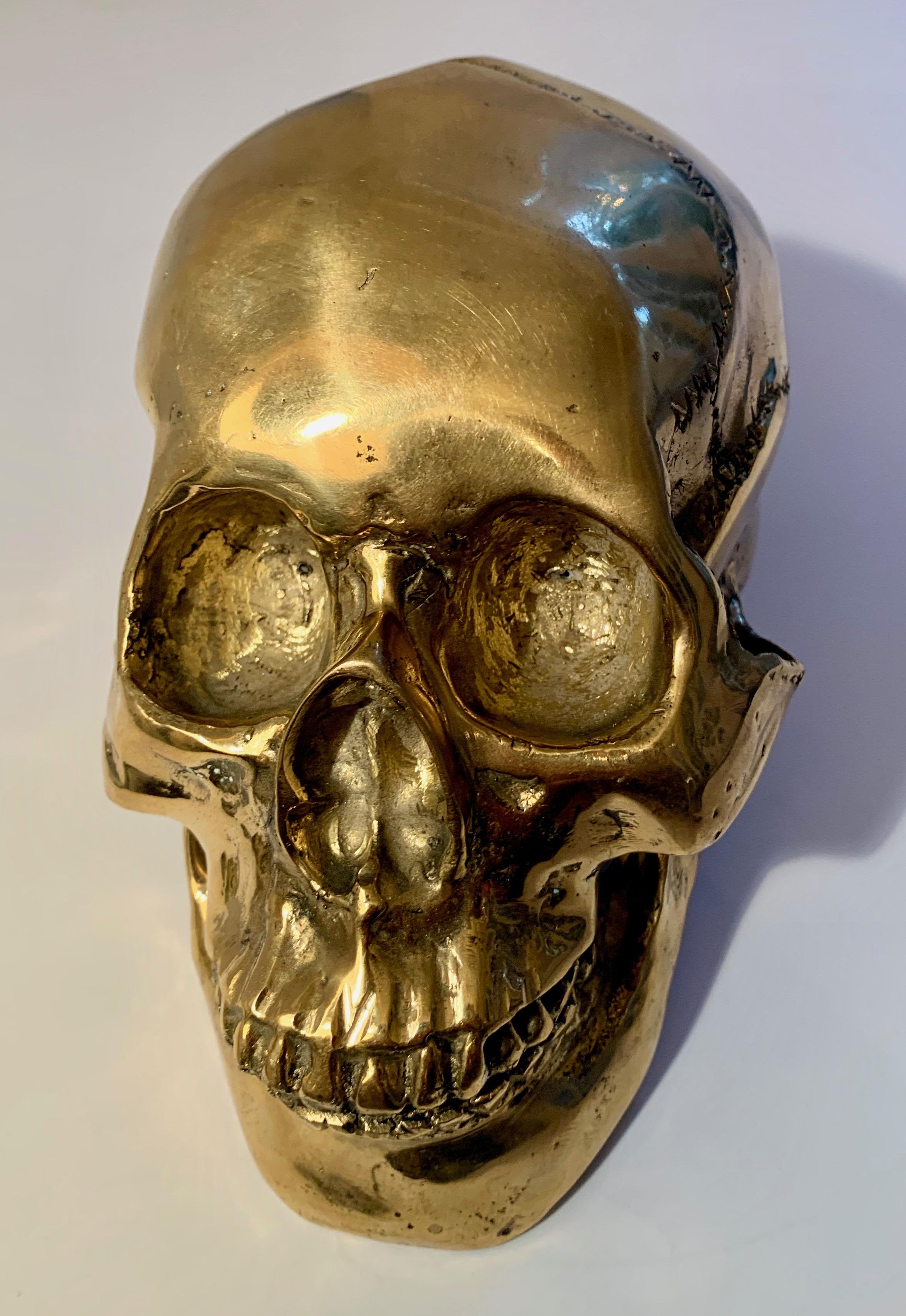 A wonderful brass skull - from a decorative statement piece to use as a bookend or paper weight. A wonderful piece for many environments. Holiday gifts.