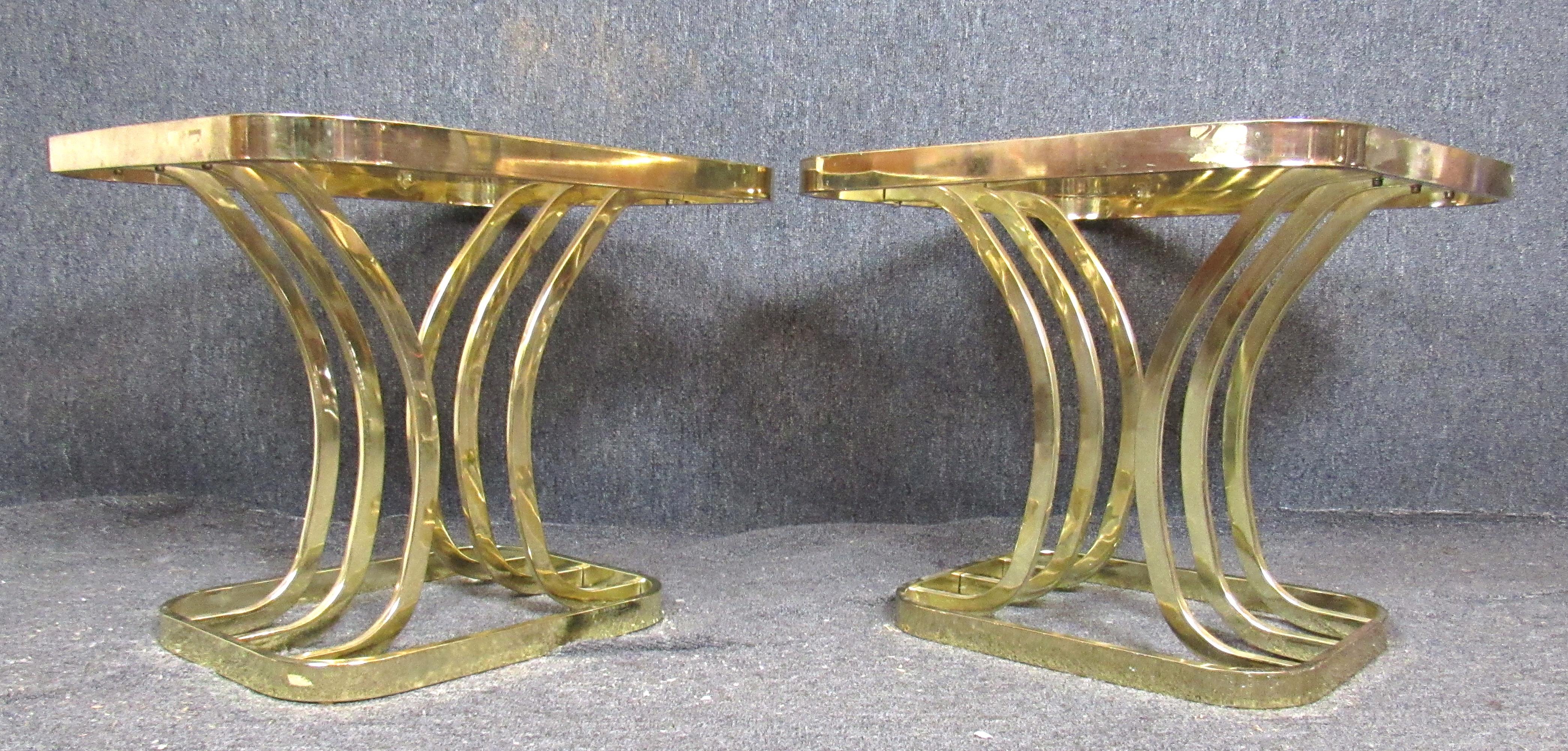 Pair of bright brass base side tables with smoked glass. Attractive arched supports on a square base.
Please confirm location.