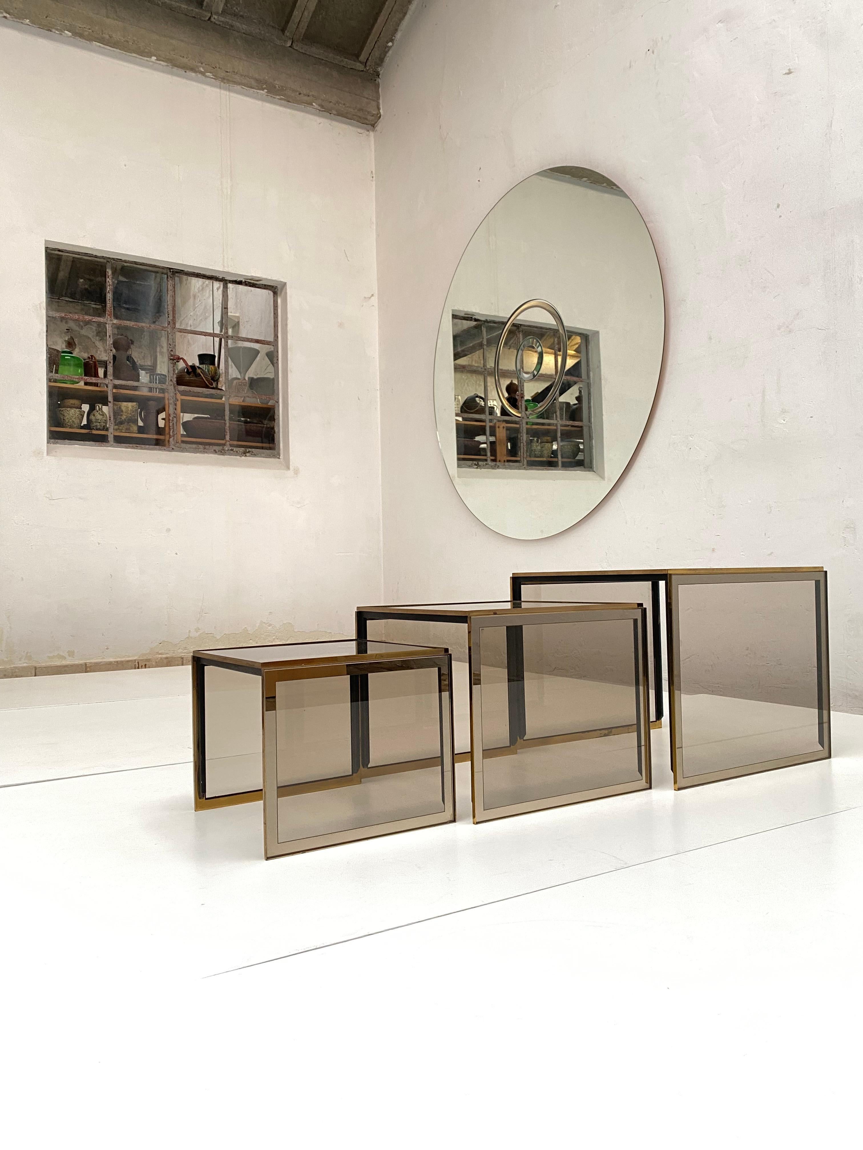 Glamourous set of Nesting Tables by Renato Zevi Italy late 1970's 

High quality produced with black enamel steel frames, brass detailing and smoked and mirrored tempered glass

Looking very elegant and very functional to implement into your