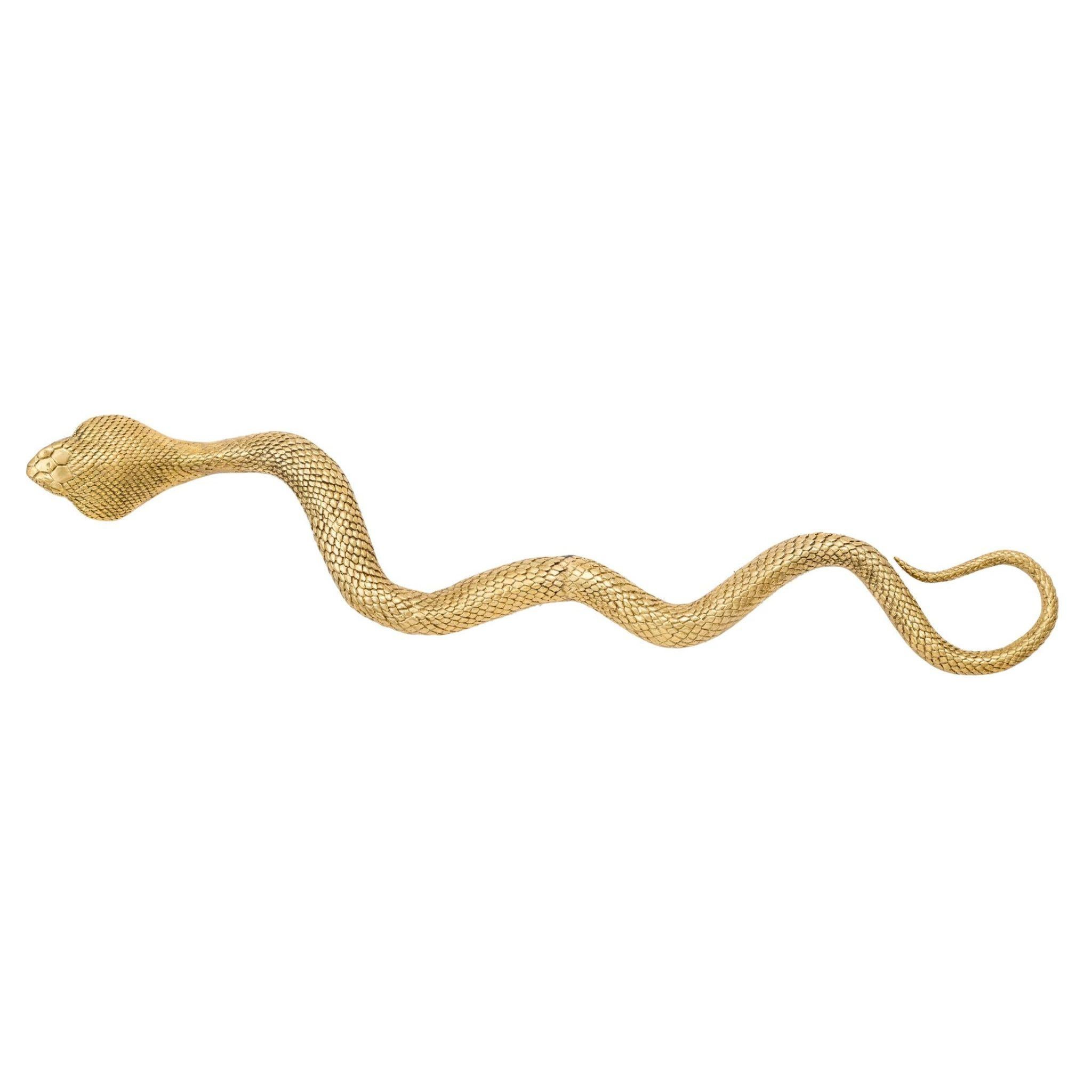 This brass decorative cobra is a stunning statement piece that is sure to catch the eye of anyone who enters your space. The intricate details of the cobra's scales and the fluidity of its body make it a true work of art. The golden sheen of the