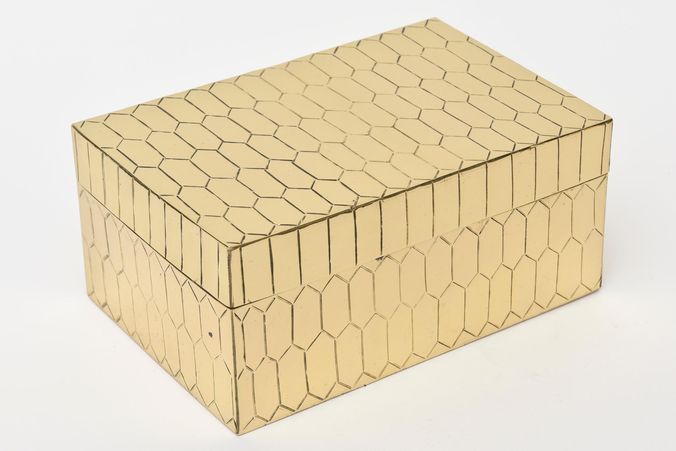This lovely large textured snakeskin honeycomb patterned hinged brass box is a great accessory for any desk, cocktail table or console.
It is vintage from the 1970s. It has been polished and the inside is gilded brass.
 