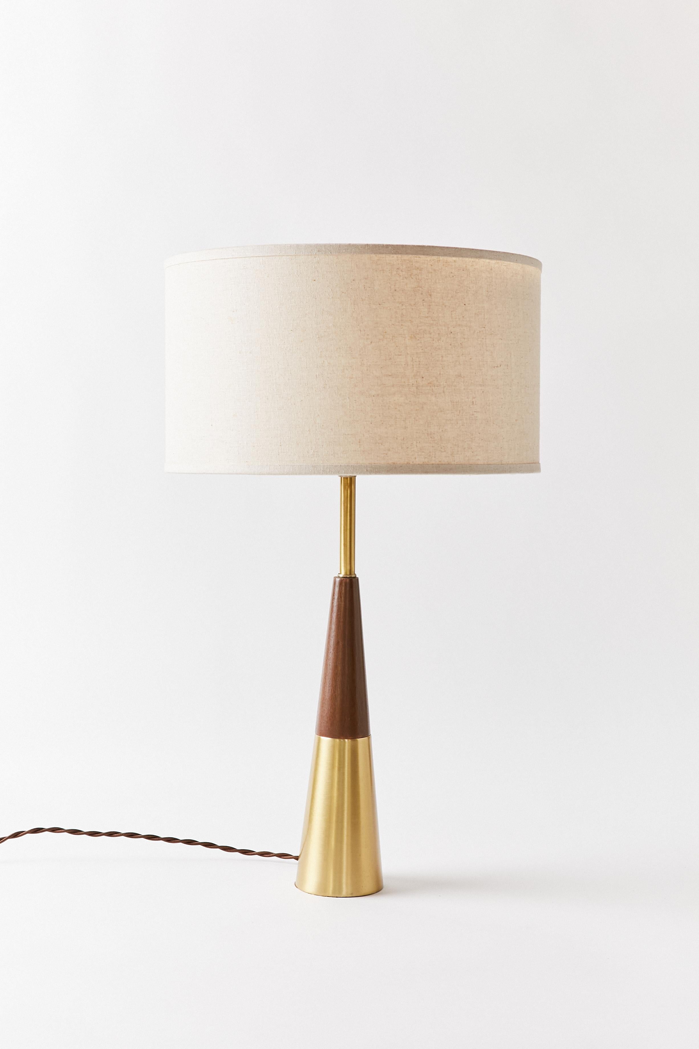 Cone table lamp in Swedish brass and solid walnut. Designed by Tony Paul for Westwood Industries.
This item has been rewired with braided cloth cord and new hardware. This lamp does not include shade or harp.