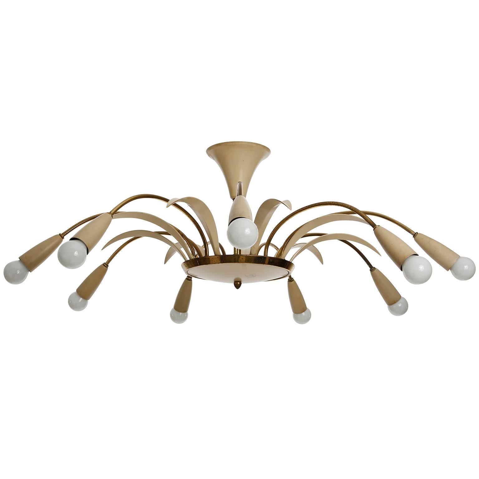 An Italian nine-arm (9-arm) flush mount light fixture or chandelier, manufactured in Mid-Century, circa 1960 (late 1950s or early 1960s).
The lamp is made of brass and creme painted details. Brass is patinated.
The fixture has nine sockets sockets