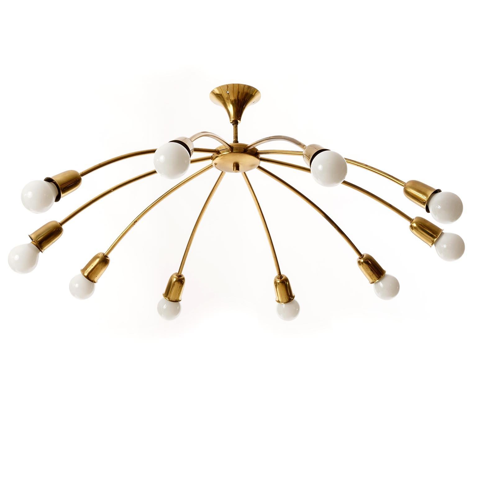 A ten-arm brass spider light fixture by Rupert Nikoll, Austria, Vienna, manufactured in midcentury in 1960s.
This beautiful fixture is made of natural aged solid brass in a warm rich tone with little and very nice patina. It has 10 curved arms with
