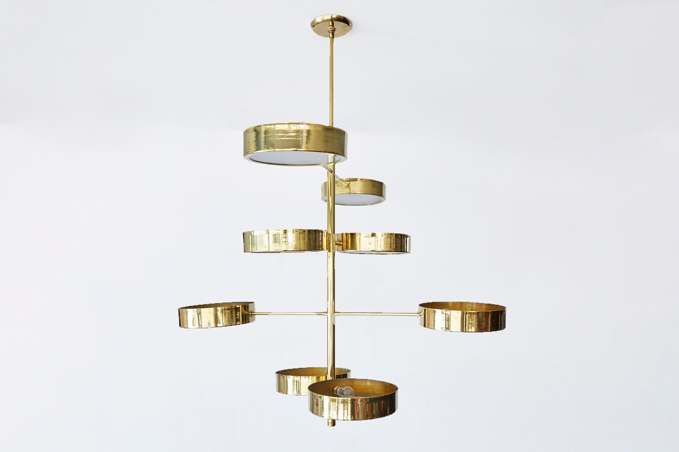 Large brass and glass spiral disc light in the style of Stilnovo. 8 brass discs with milk glass shades on varying length arms. Newly produced in Italy and newly wired to American standards.