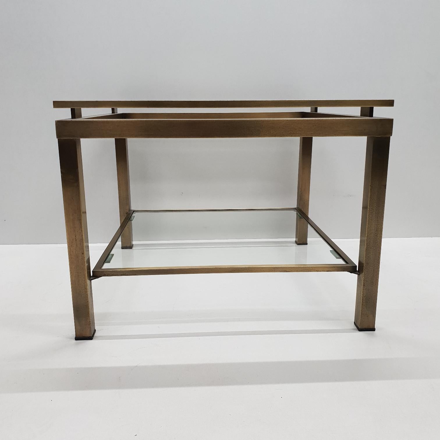 Brass square 2-tier side table with cut glass by Maison Jansen, 1970s
Brushed brass frame with cut glass shelves.
 