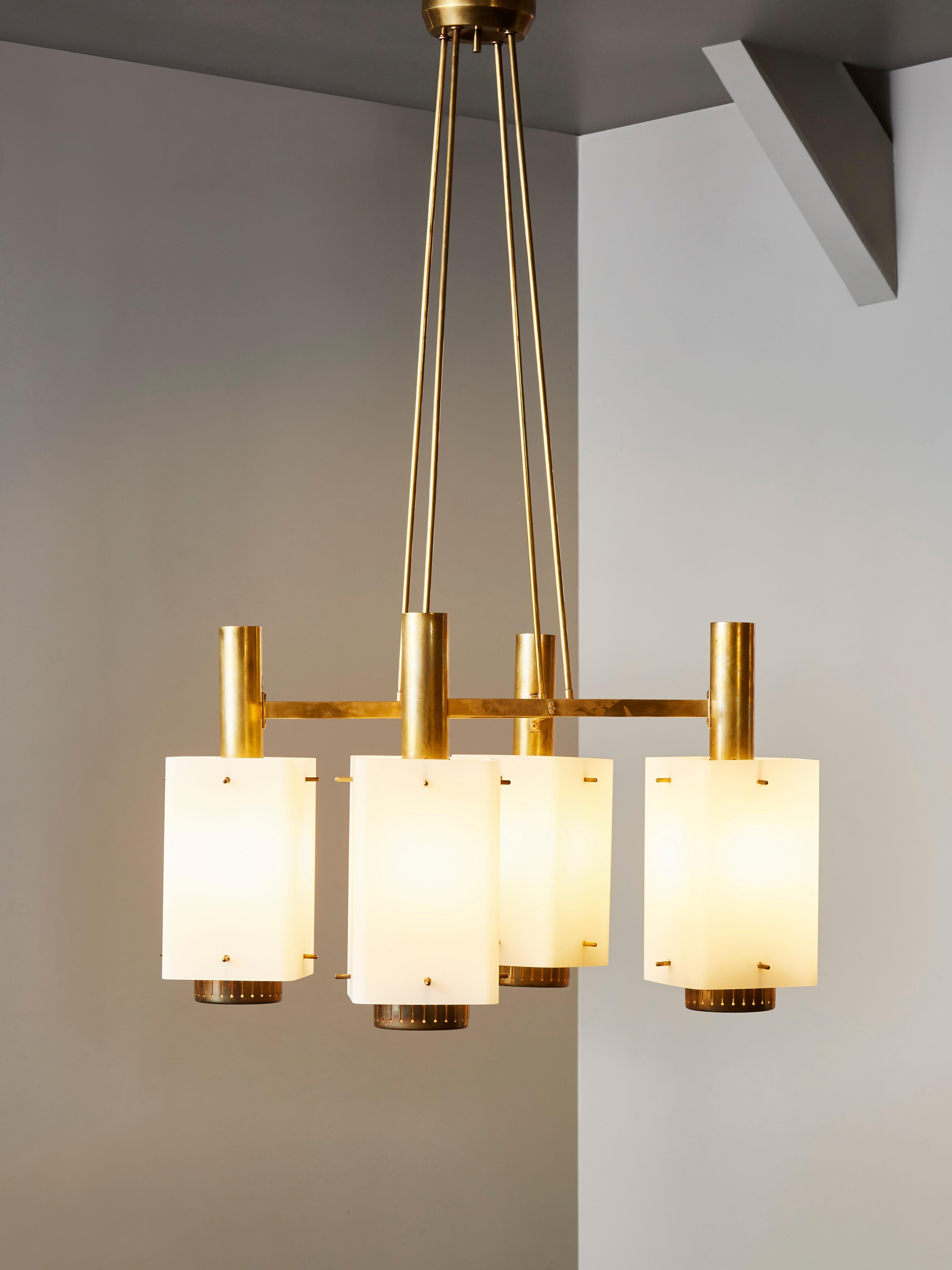 Original Stilnovo chandelier made of a brass structure holding four opaline glass sconces. 

Manufacturer sticker on one arm.