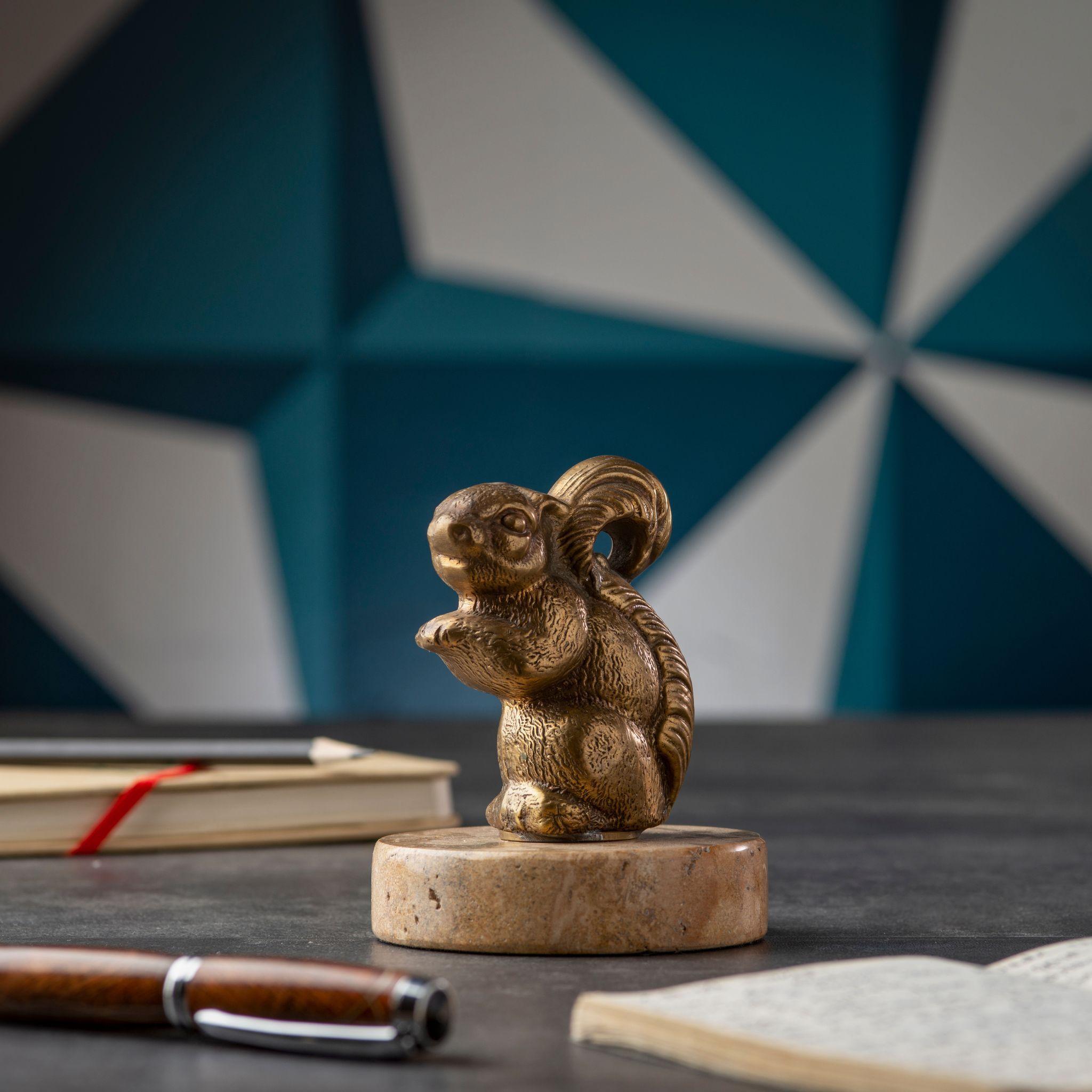 Bring a touch of nature to your home with the elegant brass squirrel with marble base. This beautiful piece features a brass squirrel figurine perched on a sturdy marble base, making it a stunning addition to any room in your home. The intricate