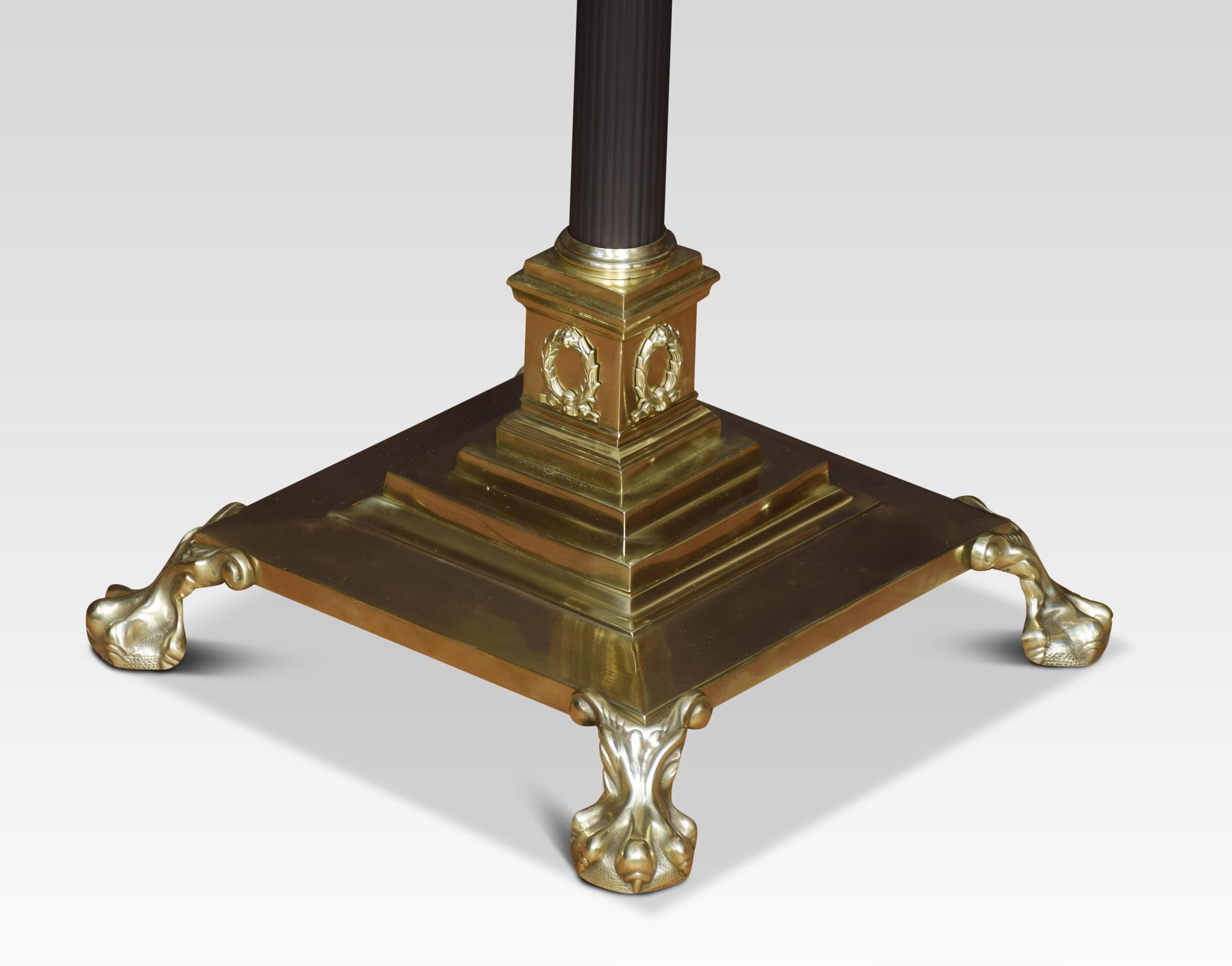 19th century brass standard lamp. Having ebonized Corinthian column and adjustable stem, on a stepped square base with paw feet. Dimensions
Height 53.5 inches adjustable 73.5 inches
Width 14.5 inches
Depth 14.5 inches.