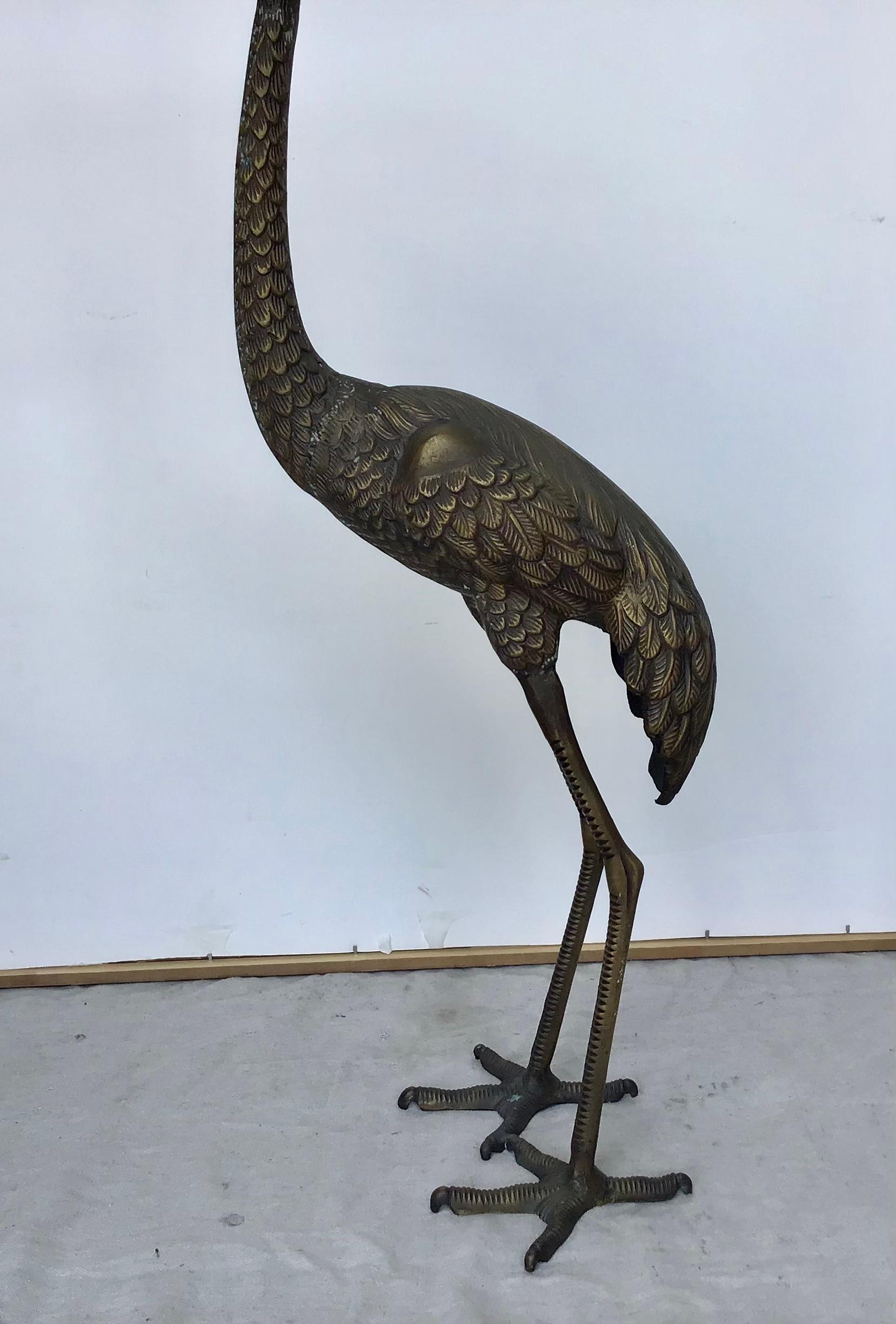 Brass standing Crane garden statue. Nice patina. High quality bronze metal 32 inches tall standing crane statue. Unsigned, Clean pre-owned condition.