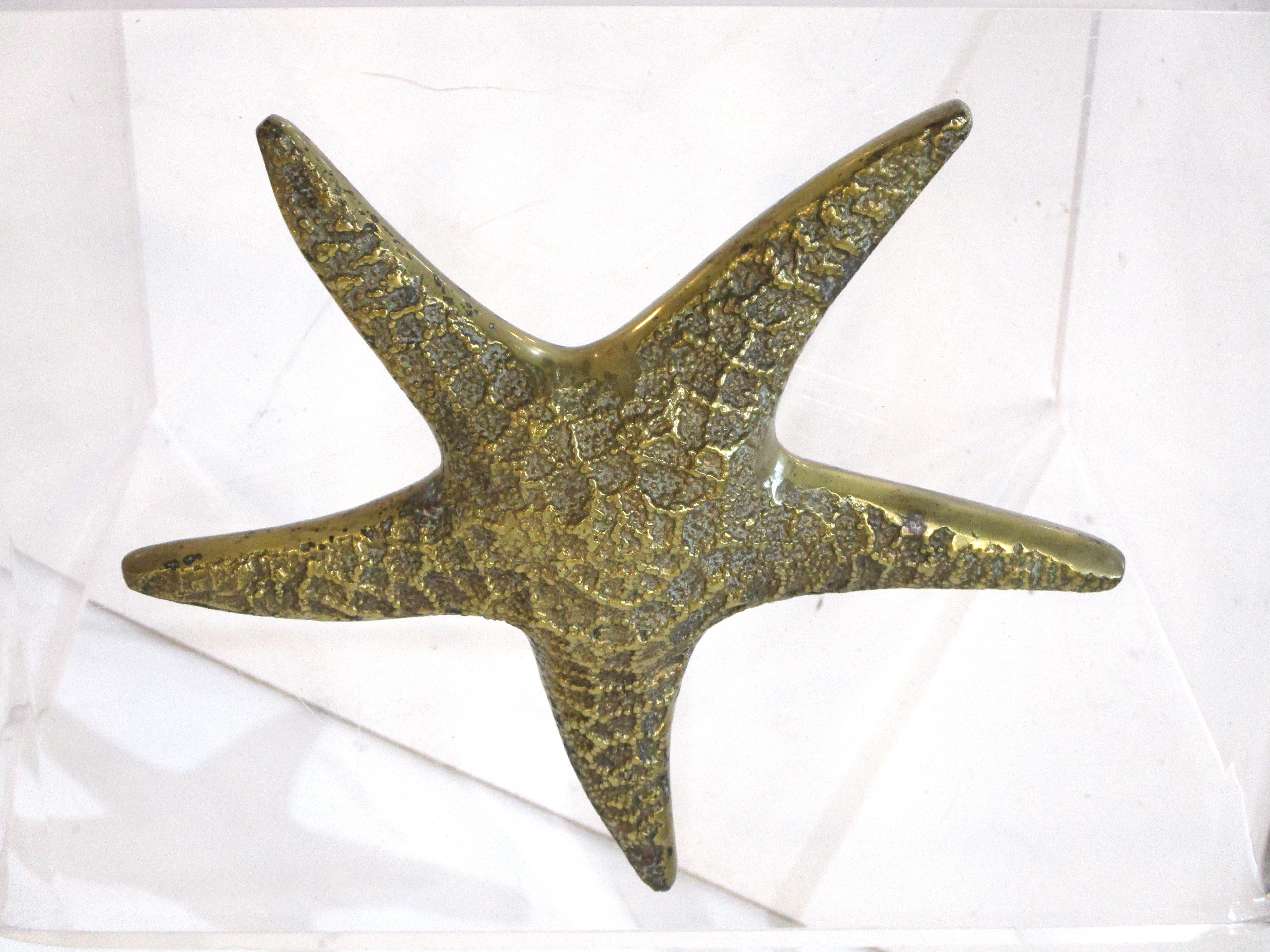 A nicely cast starfish paperweight, sculpture or hanging sculpture since it has a hook to the backside. Well made and can be used in the office or as a decorative accessory, made in Korea.