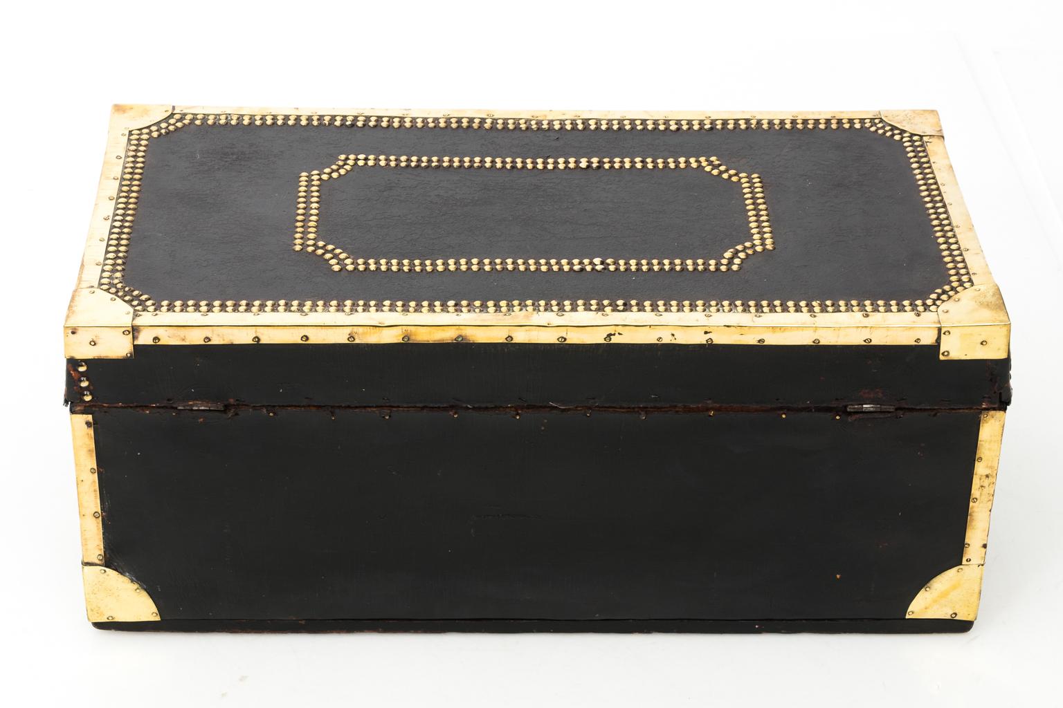 Leather steamship trunk with brass studded trim and square panel detail on the lid, circa 1860.
 