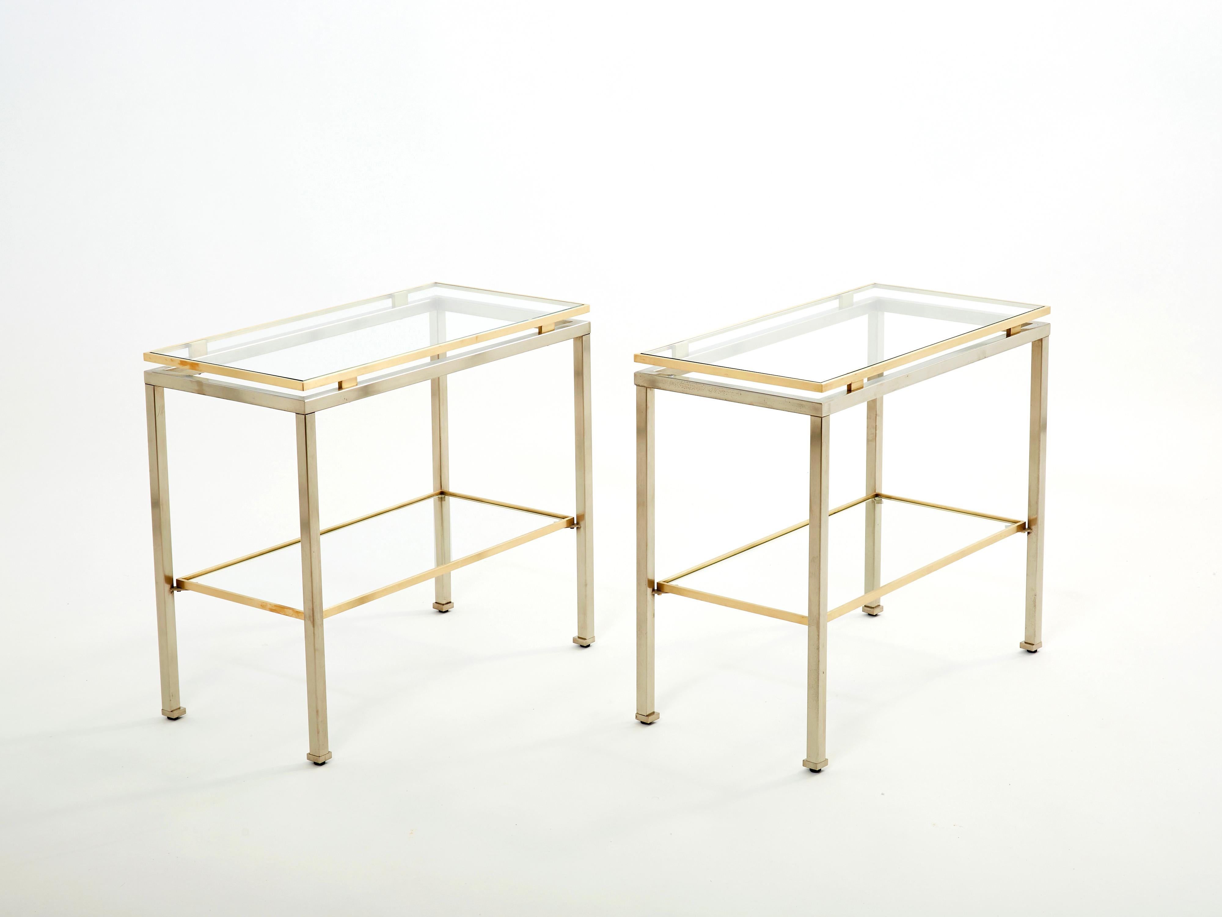 Simple lines point to these two-tier end tables with French midcentury roots. Designed by Guy Lefevre for Maison Jansen, it features smooth steel legs with brass top and accents, and transparent glass tops. Its symmetry, elevated glass, and strong