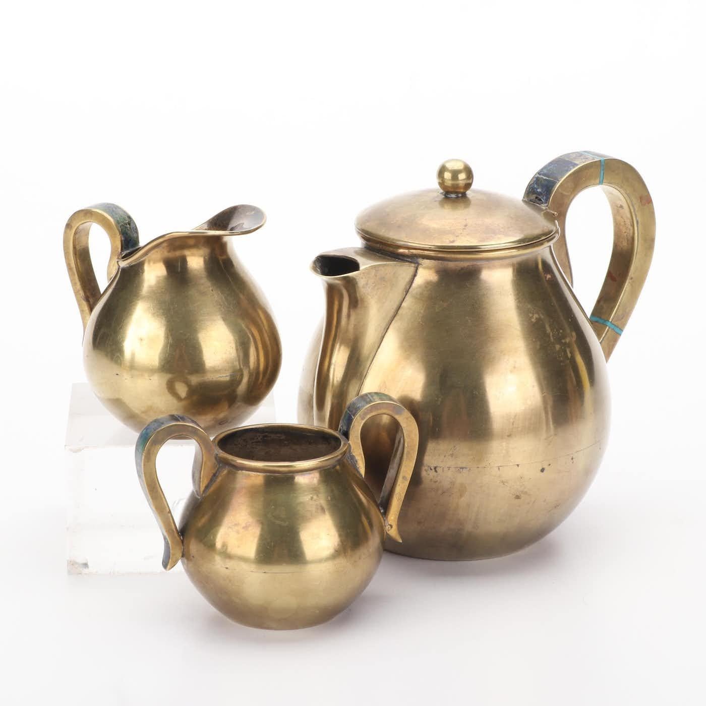 Introducing the exquisite Brass & Stone Inlay by Justo Lucio Castillo for Los Castillo, Mexico, a true testament to the artistry of 1960's design. This meticulously crafted set of tea, sugar and creamer pots is a striking addition to any discerning