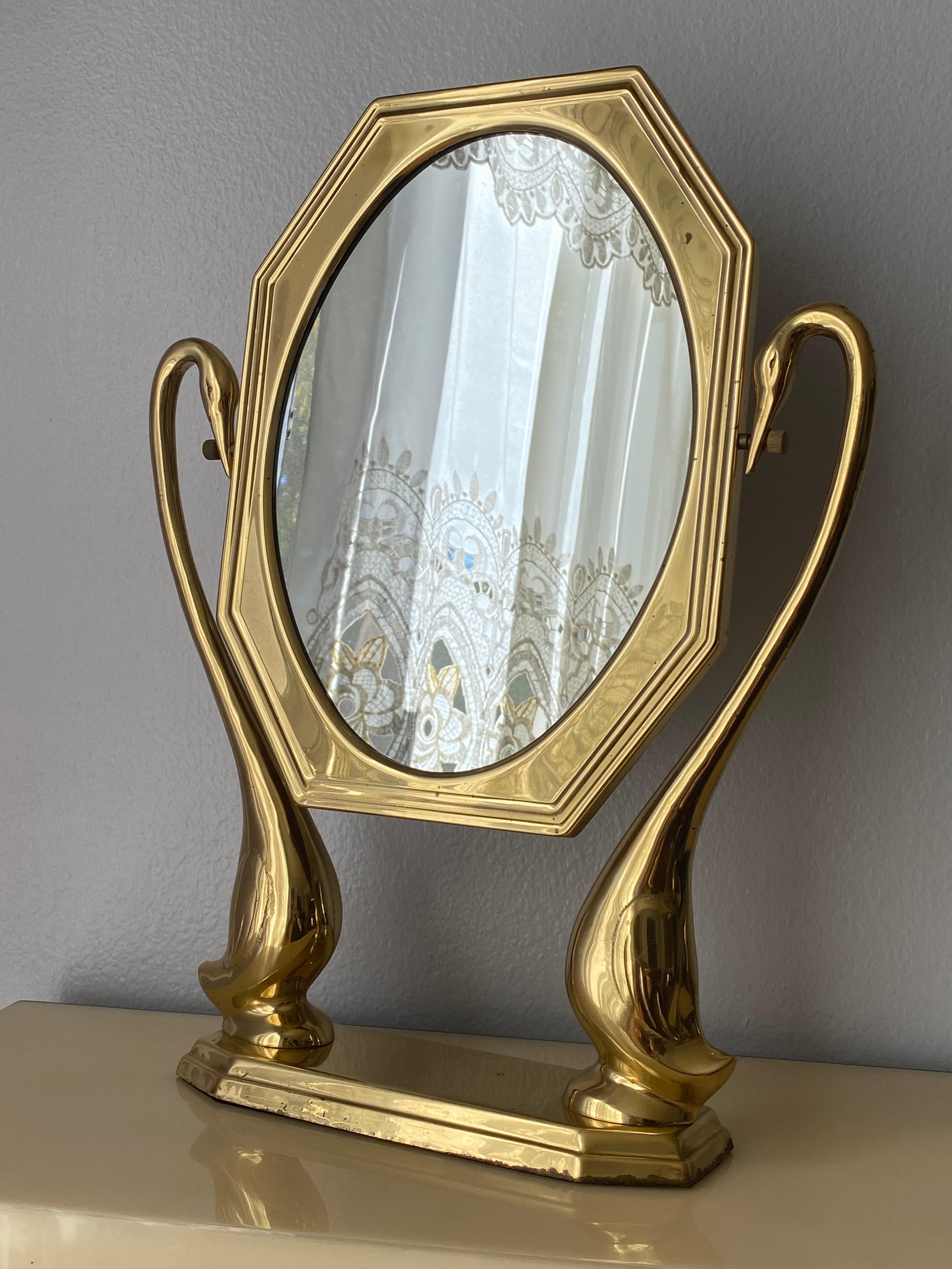 Brass swan motif vanity mirror. Oval mirror itself is 13.5